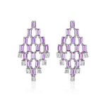 Art Deco Chandelier Earrings in white gold featuring geometric design with emerald cut diamonds and lavender sapphires.