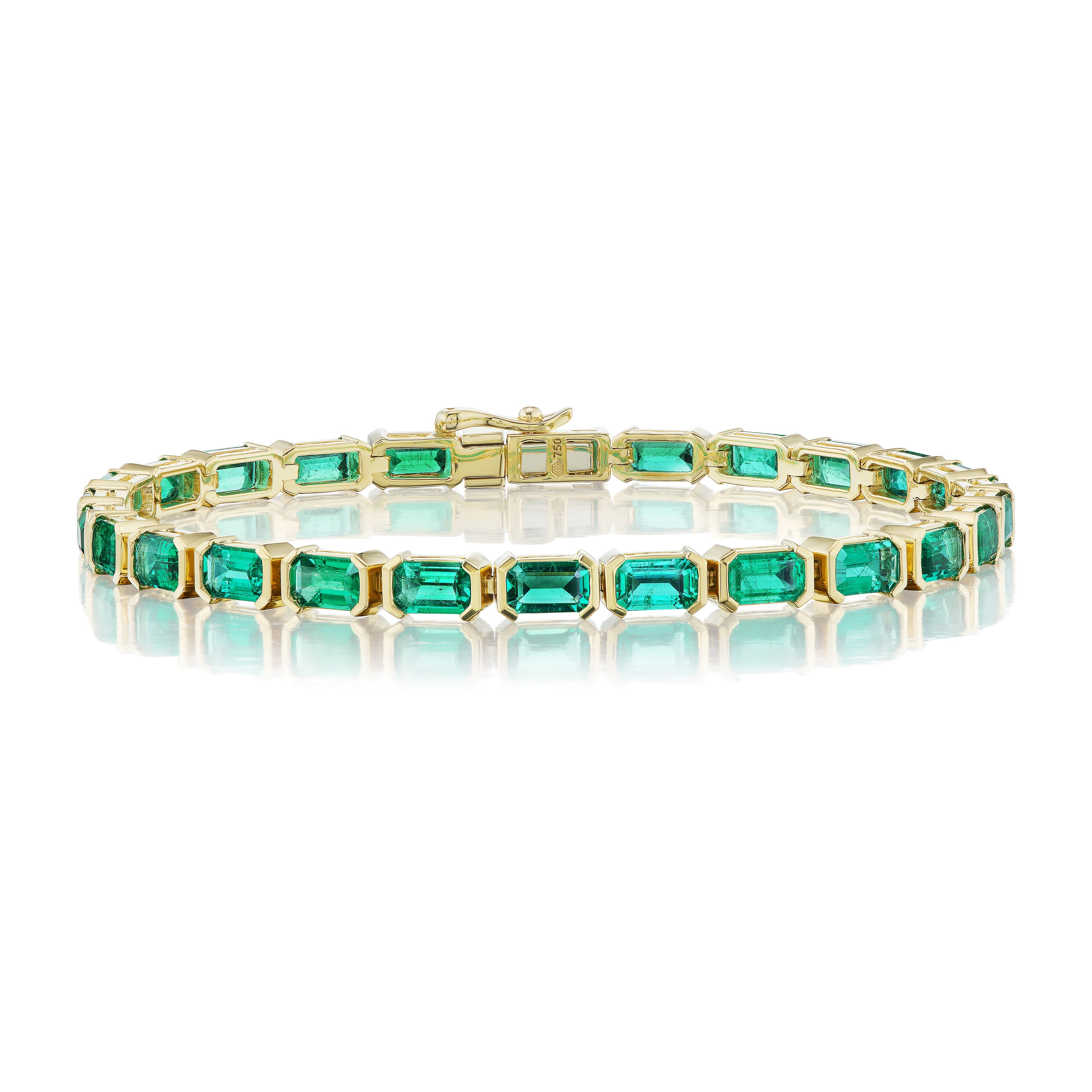 The East-West Set Emerald Cut Emerald Tennis Bracelet in Yellow Gold features a row of emerald cut emeralds in individual 18K gold frames, elegantly displayed against a white background.