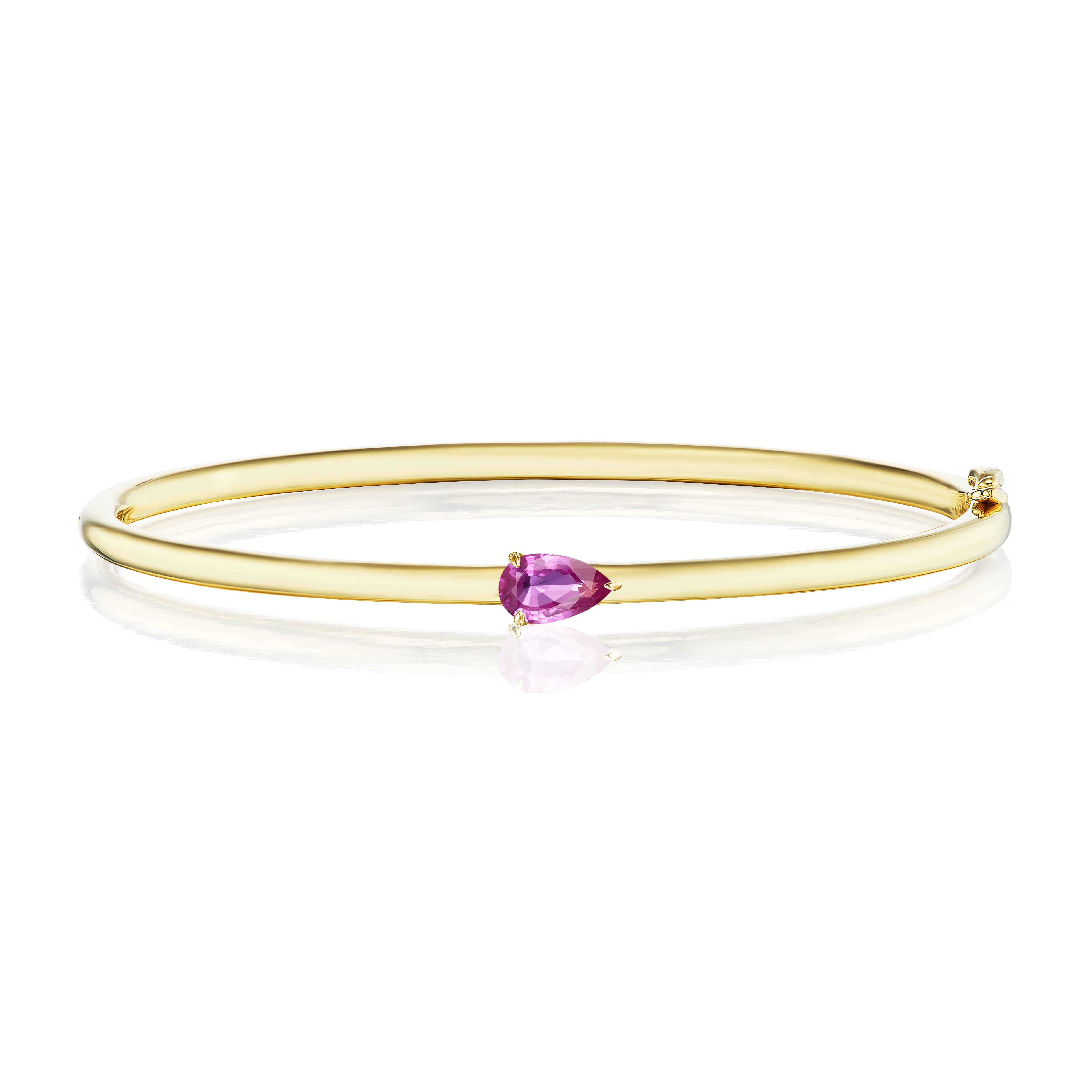 The East-West Pear Shape Solitaire Pink Sapphire Bangle in Yellow Gold features a single pear-shaped pink sapphire set in 18K yellow gold, shown against a white background.