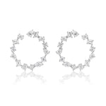The Mixed Shape Diamond Front to Back Hoops in White Gold are circular earrings featuring round brilliant diamonds and assorted gemstones in various shapes, set in 18K white gold and shown against a white background.