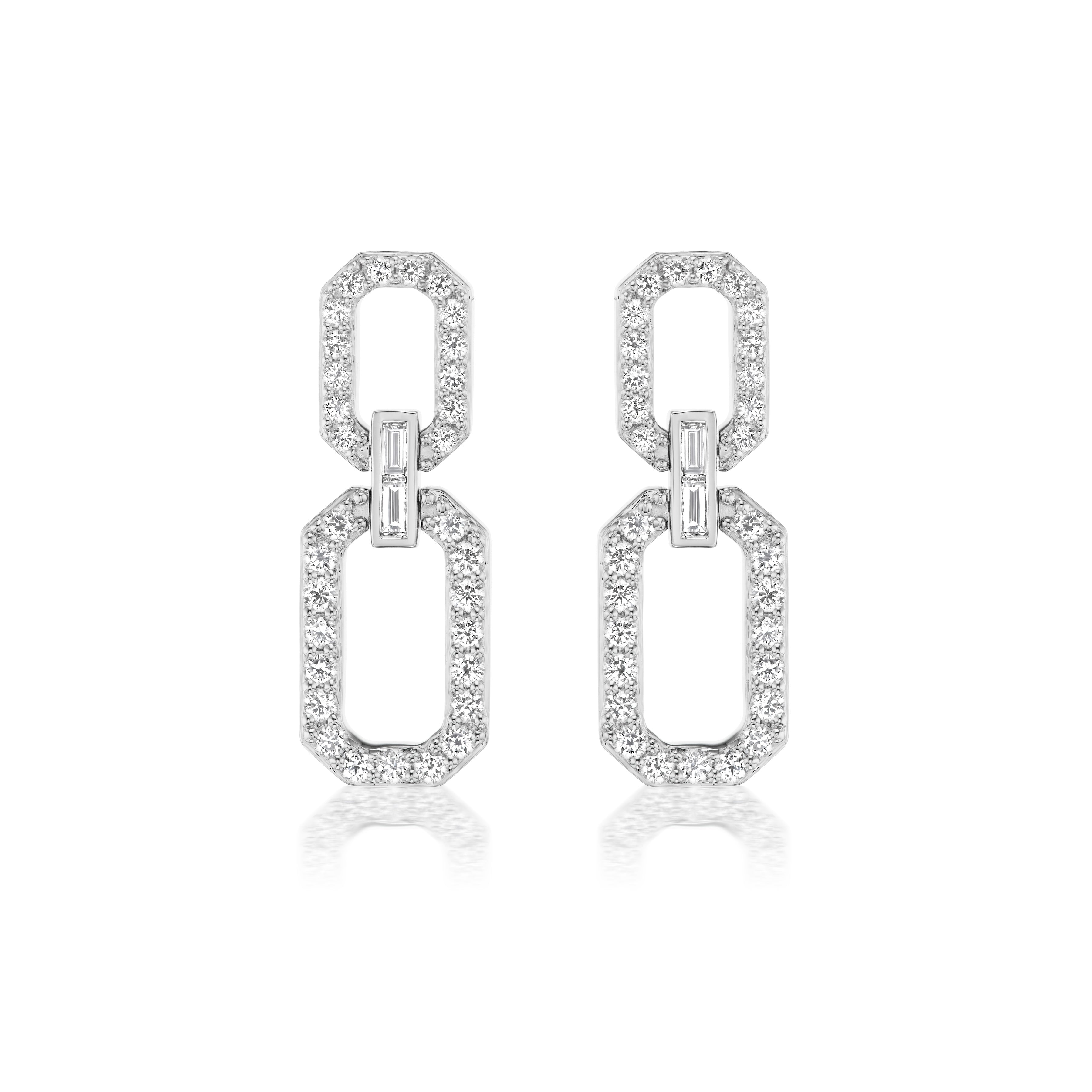 The Elongated Octagon Pavé Drop Earrings feature two linked octagonal shapes adorned with sparkling baguette diamonds, set in lustrous white gold.