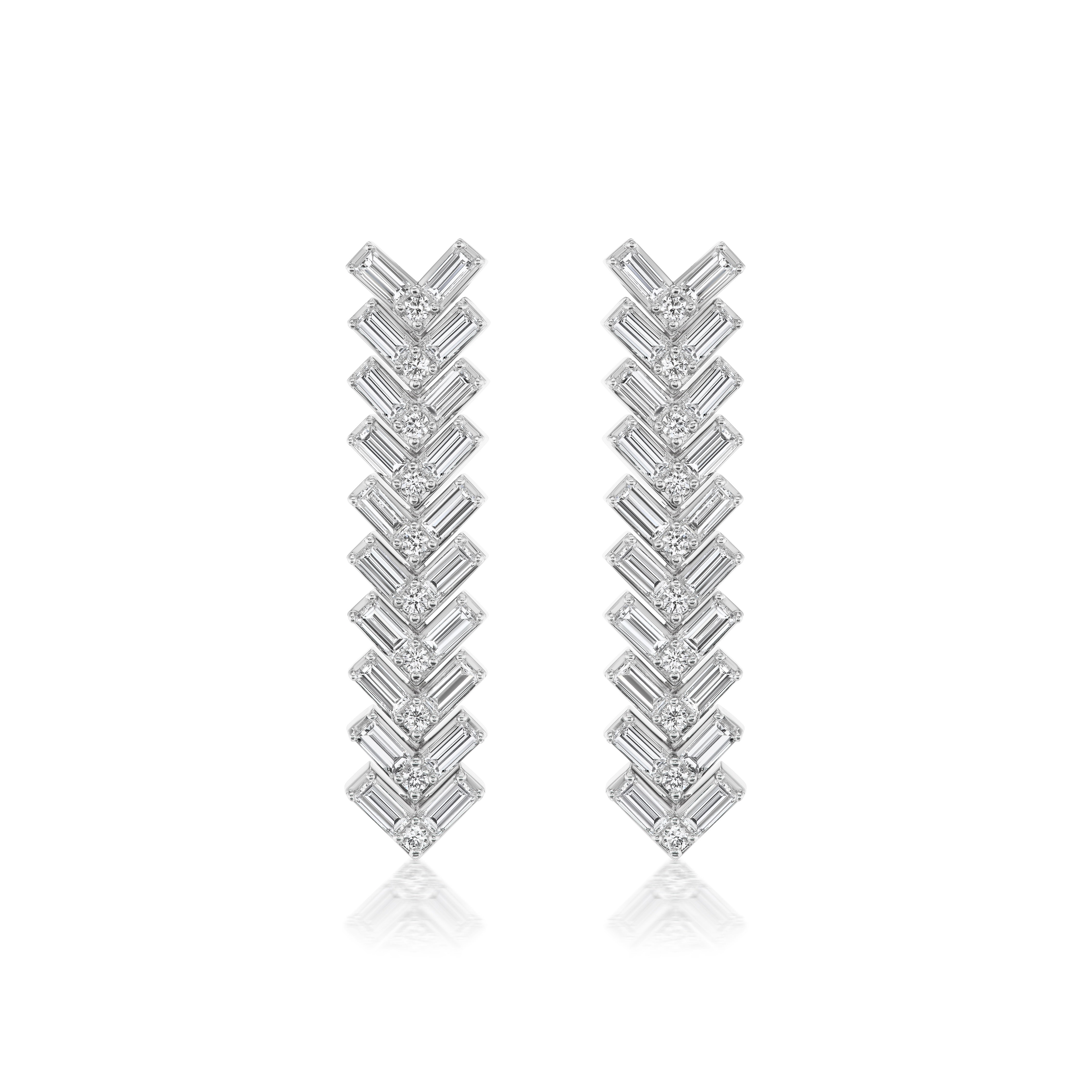 Chevron Drop Earrings in White Gold feature a modern, symmetrical design with stacked, sparkling V-shaped segments set with baguette and round diamonds, creating a reflective look inspired by classic elegance.