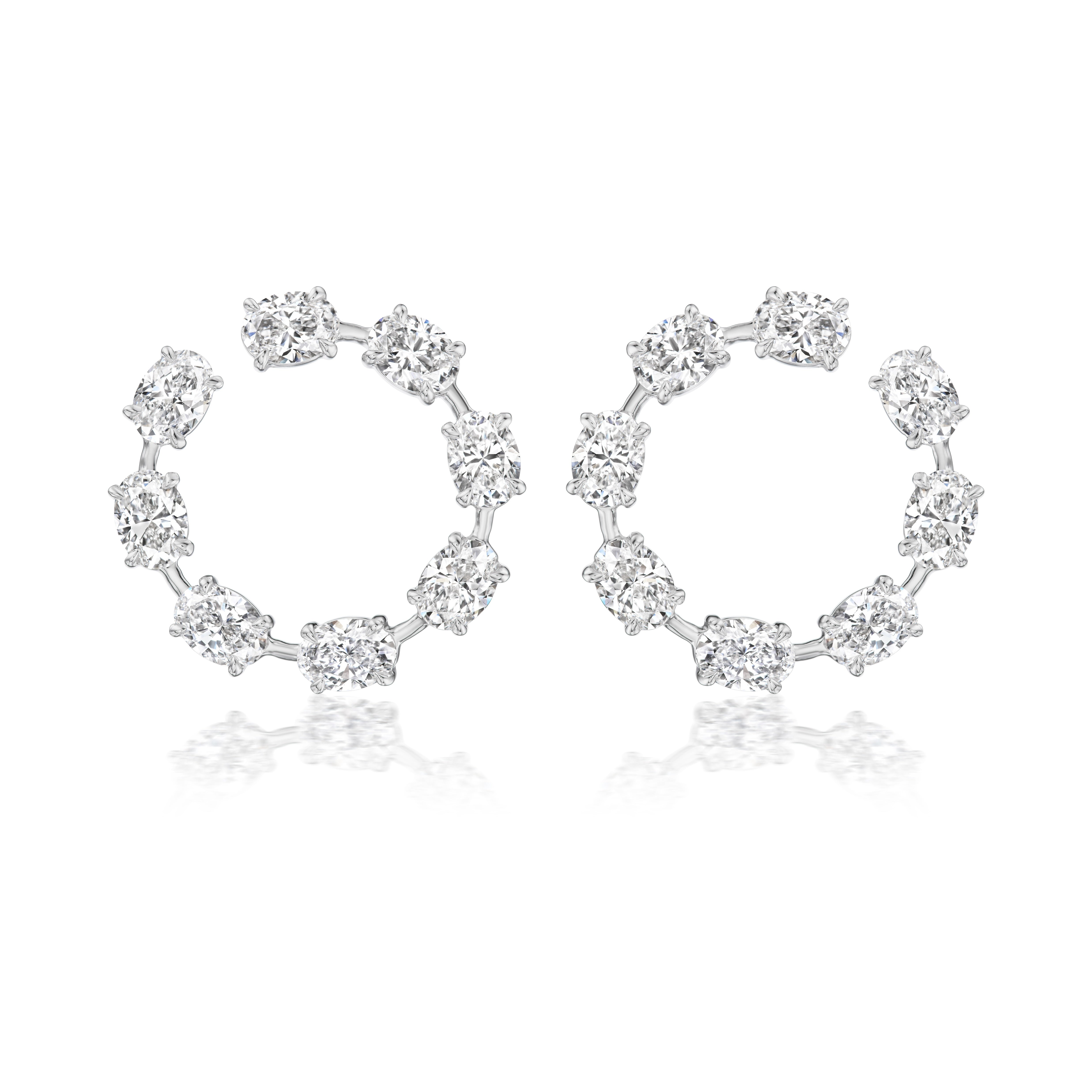 The Oval Diamond Front to Back Hoop Earrings in white gold feature eleven round diamonds set evenly along each 18k hoop, displayed on a white background with a subtle reflection.
