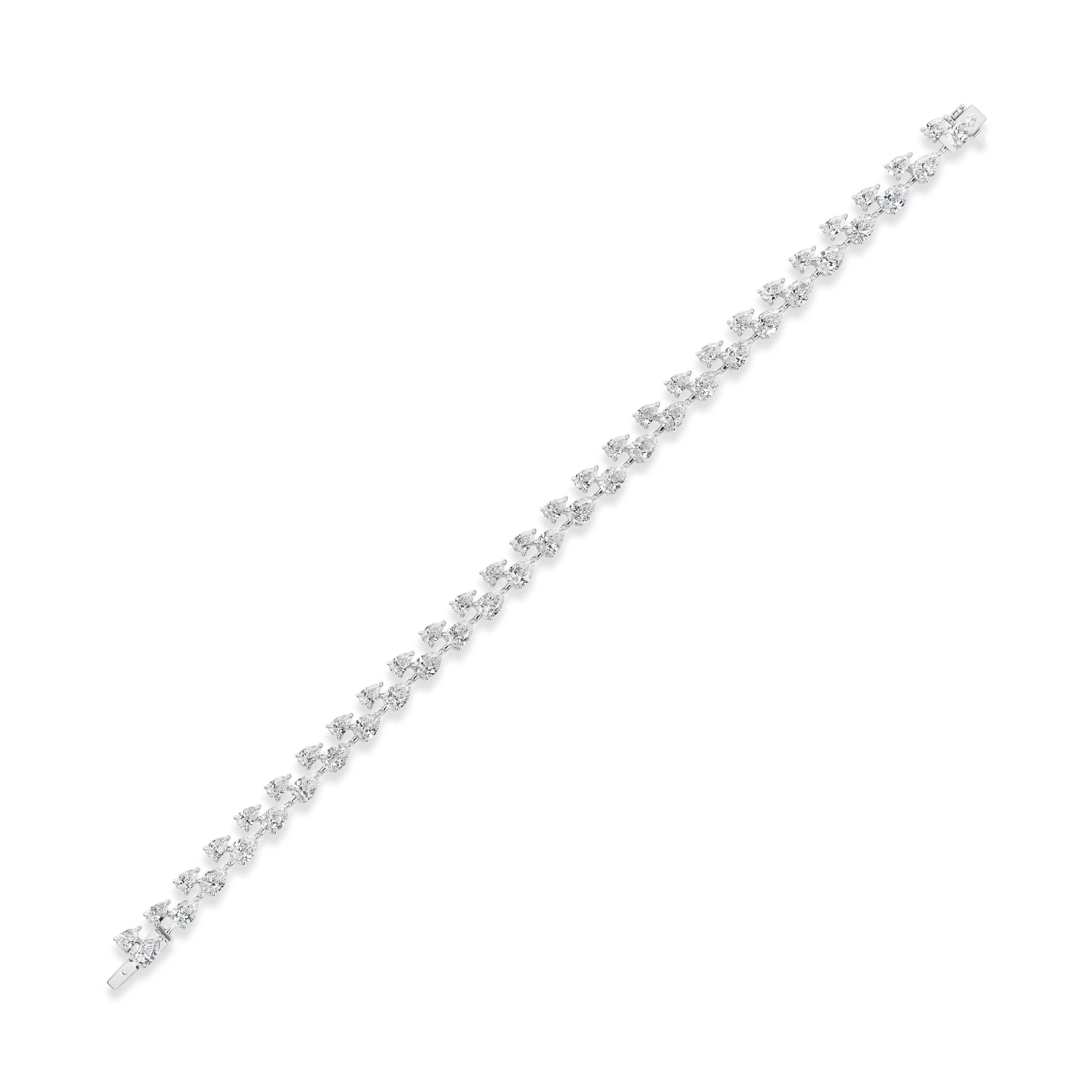 The Duo Pear Diamond Tennis Bracelet in white gold features a slim band with sparkling round and pear-shaped diamonds set in a straight line, showcased against a plain white background.