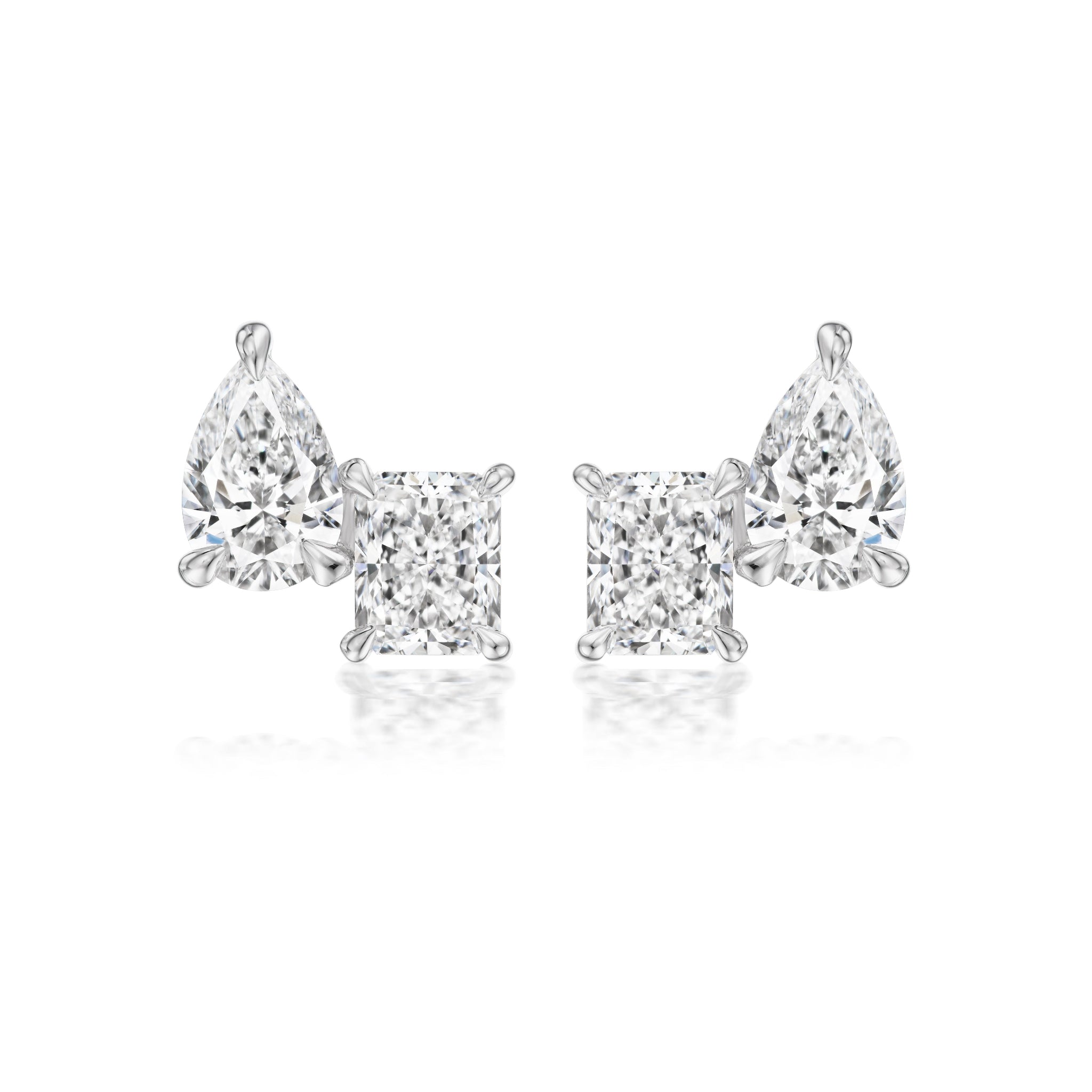 The Mixed Shape Duo Studs feature radiant cut and pear-shaped diamonds set in 18k white gold, displayed on a white background.