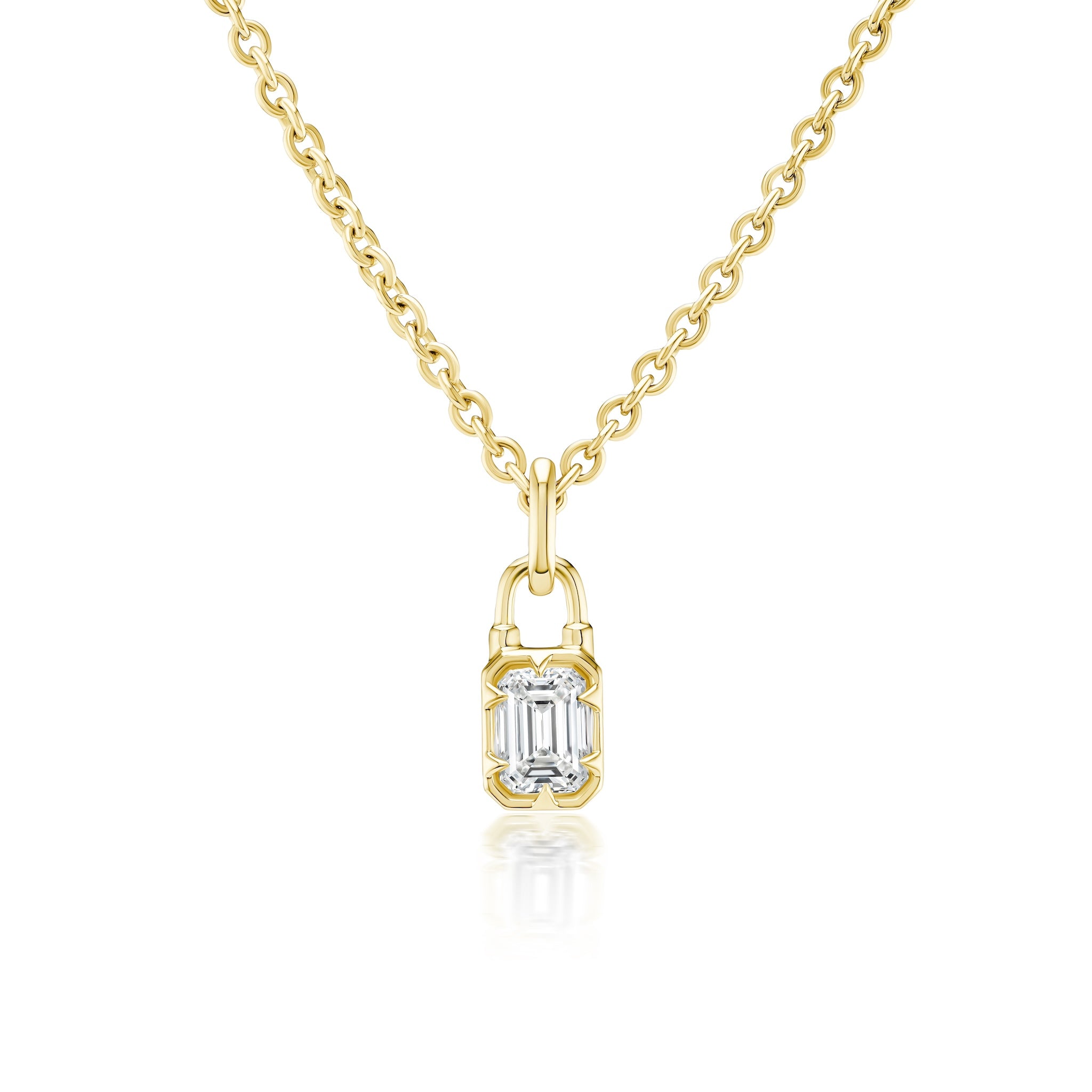 The Locket Motif Diamond Pendant Necklace showcases a small emerald-cut diamond set in a gold frame with a locket-inspired design, beautifully displayed against a white background.