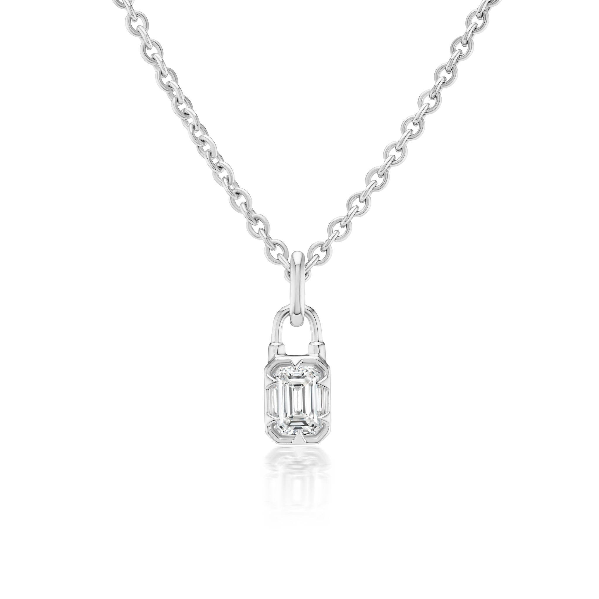 The Locket Motif Diamond Pendant Necklace features a silver chain and a small rectangular pendant with an emerald-cut diamond at its center, displayed on a white background.