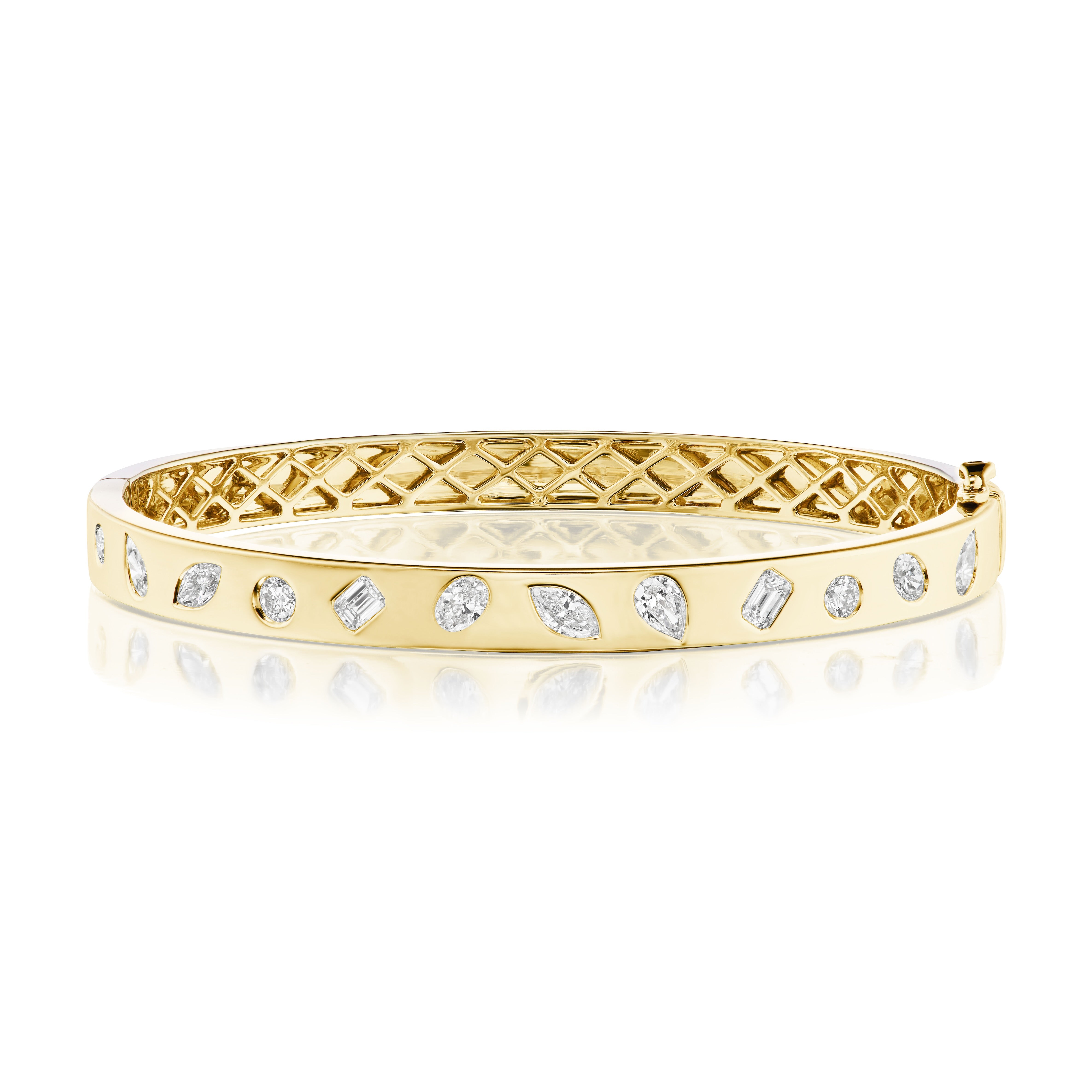 The Burnish Set Mixed Shape Diamond Bangle in 18K gold features an intricate inner lattice and mixed shape diamonds on the exterior, elegantly presented on a reflective surface.
