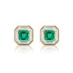 The Mosaic Studs in Yellow Gold showcase Asscher Cut Emeralds at the center, framed by sparkling baguette diamonds and set in 18K yellow gold, displayed on a white background.