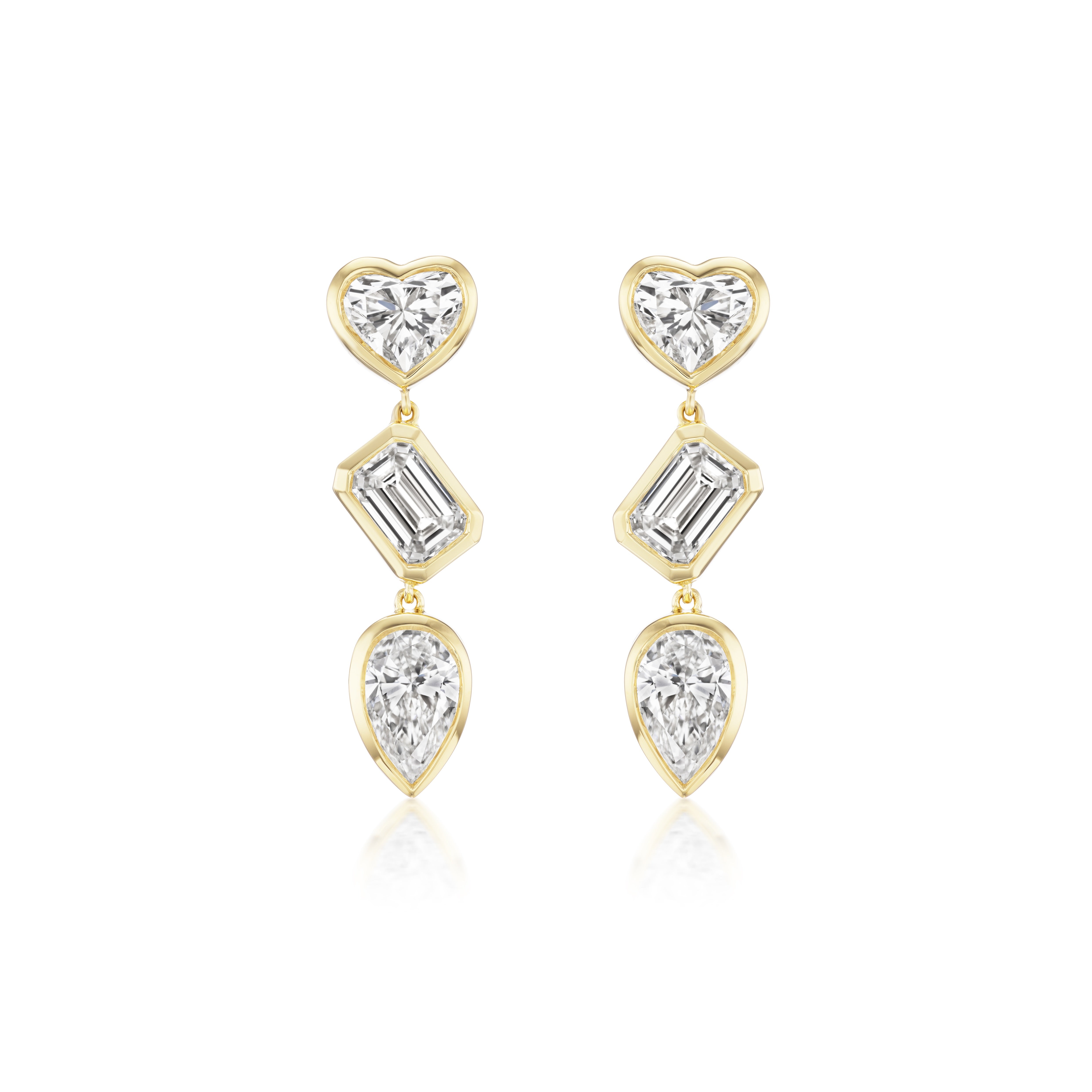The Bezel Set Mixed Shape Diamond Drop Earrings feature three bezel-set diamonds—a heart, a baguette, and a pear—outlined in gold and arranged vertically for an elegant 18K gold look, perfect for any occasion.