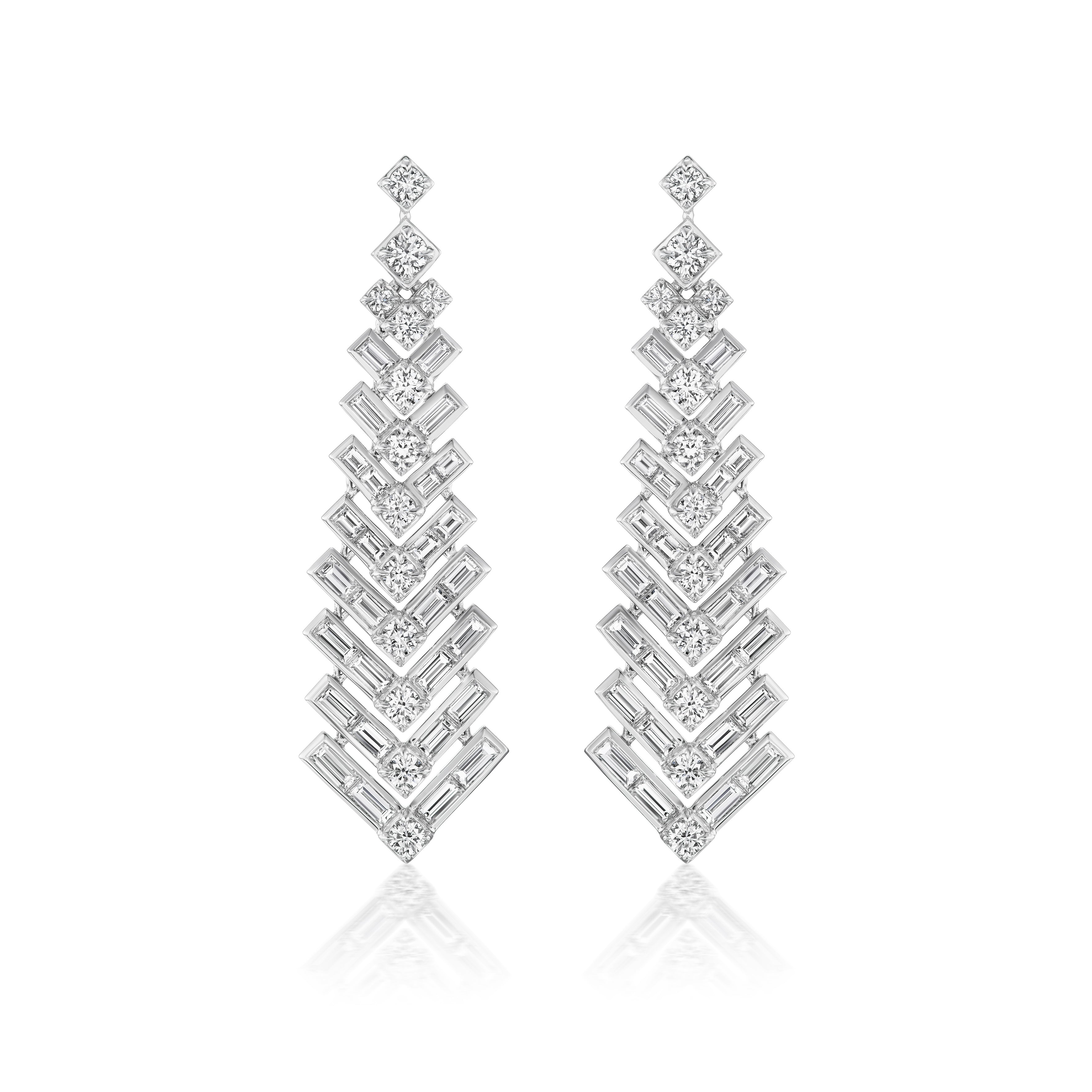 Art Deco Statement Earrings in 18k white gold, featuring layered chevron patterns with round and baguette diamonds, displayed on a white background.