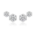 The Hexagon Bezel Set Round Diamond Duo Studs feature two clear round diamonds in hexagonal frames of different sizes, set side by side and expertly crafted in 18k gold.