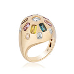 Confetti Bombé Ring in 18K yellow gold features a rounded top with baguette, oval, and round gemstones in yellow, blue, pink, and clear hues. “18K” is stamped inside the band. Stones can be customized.