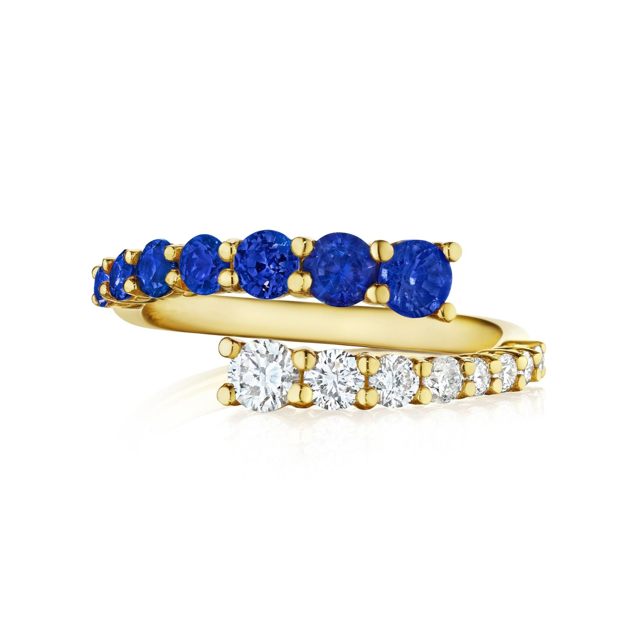The Open Space Ring with Round Diamonds and Blue Sapphires in Yellow Gold features interlocking bands—one with sapphires, the other with diamonds—both set in prongs and beautifully displayed on a white background.