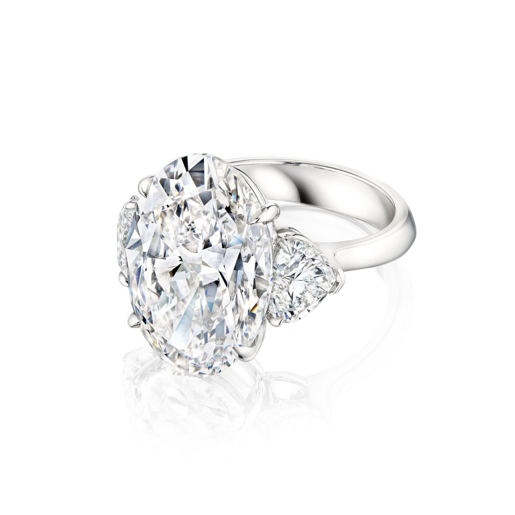 The Oval Diamond Engagement Ring with Heart Shape Side Stones is displayed on a white background, featuring a platinum band with a large oval diamond center and two heart-shaped side diamonds.