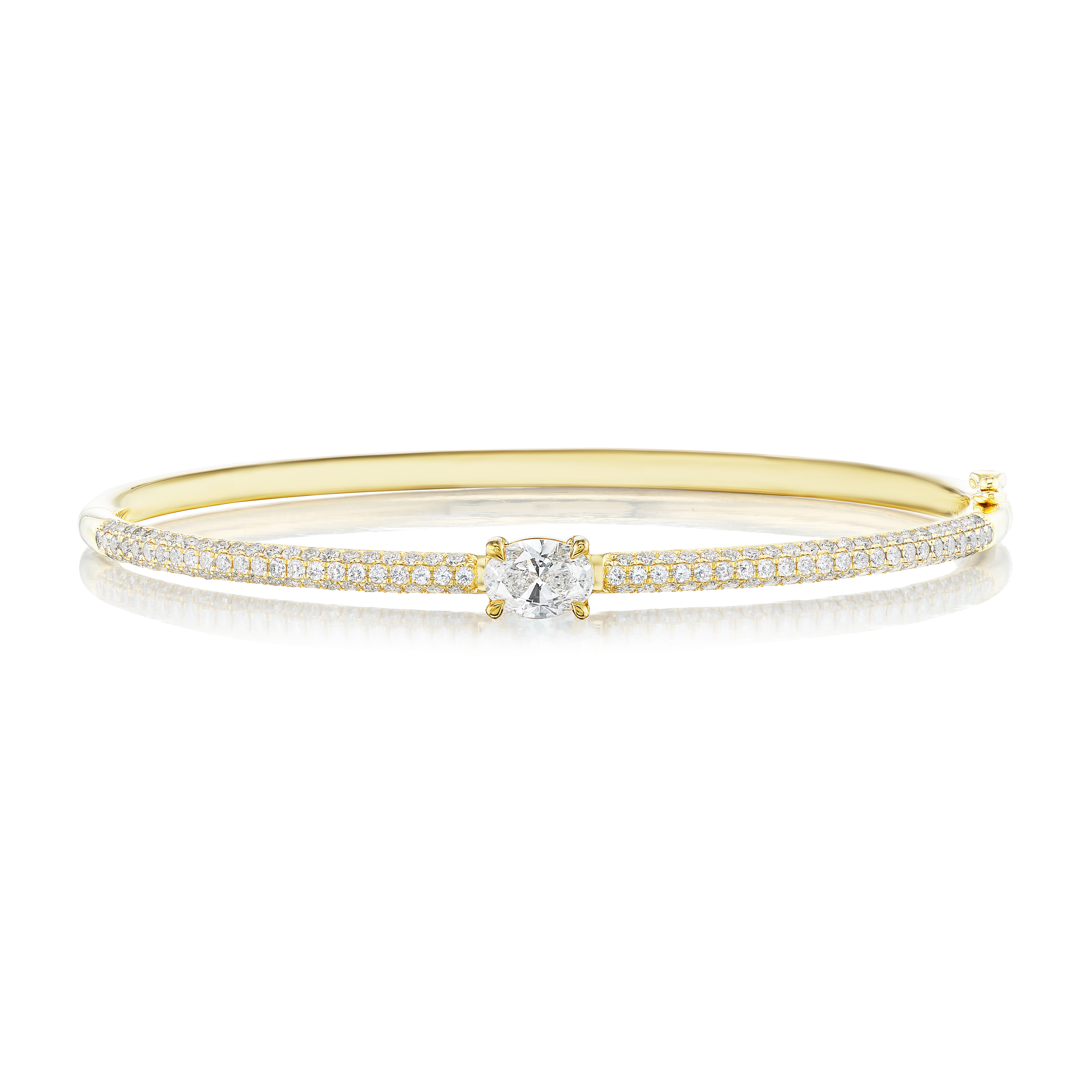 The East-West Set Oval Shape Diamond Pavé Bangle features 18k gold, two rows of pavé diamonds, and a bold oval-shaped diamond centerpiece.