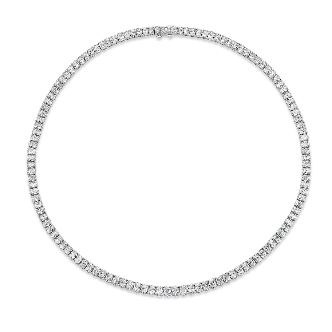 The Oval Diamond Tennis Necklace in White Gold is an elegant piece featuring closely set oval diamonds in 18K white gold, forming a complete circle.