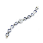 An Art Deco Cartier Sapphire and Diamond Watch with silver circular links, sapphire blue accents, connecting metal bars, and a round central clasp, displayed on a plain white background.