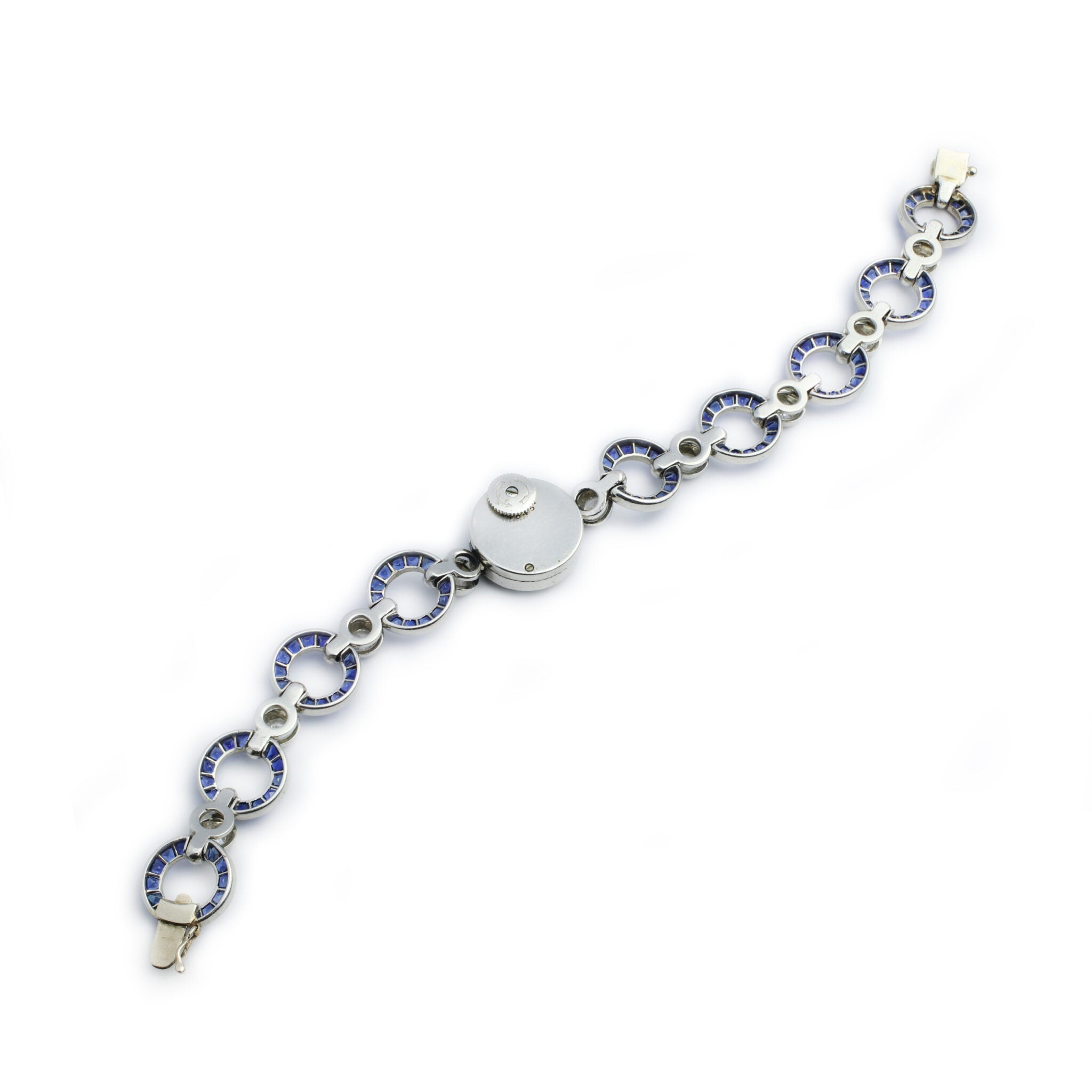 An Art Deco Cartier Sapphire and Diamond Watch with silver circular links, sapphire blue accents, connecting metal bars, and a round central clasp, displayed on a plain white background.