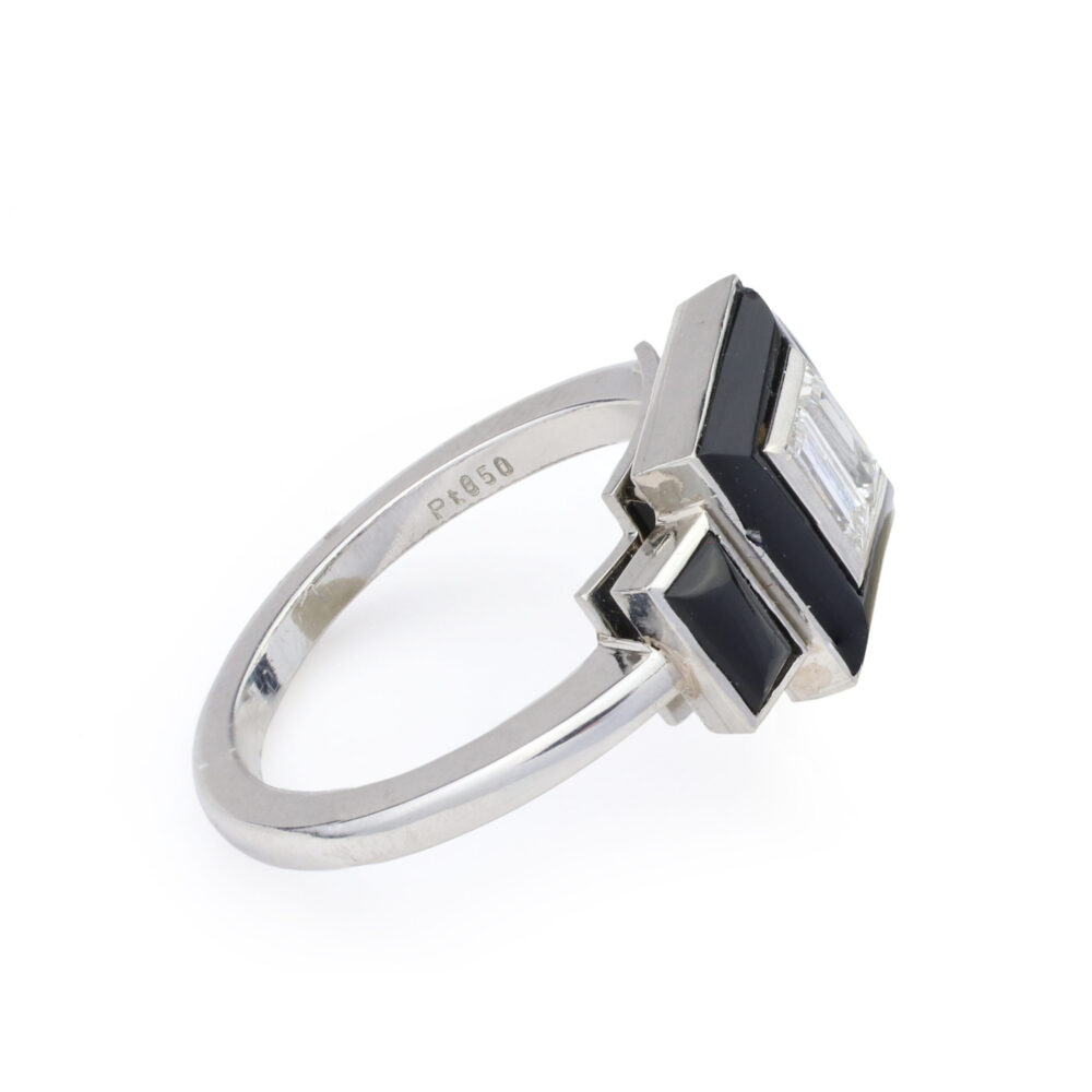 The Onyx and Diamond Ring features a platinum band (engraved Pt 850), a geometric design with a central rectangular diamond, and an onyx frame.