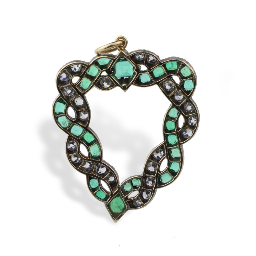 The Emerald and Diamond Pendant, circa 1890, features interwoven gold bands set with cushion-shaped emeralds and old-cut diamonds, a geometric green stone at the top, and a gold loop for hanging.