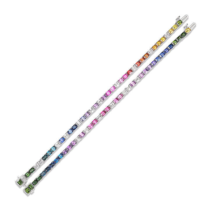 Two Multicolor Emerald Cut Sapphire Tennis Bracelets in 18K white gold feature square-cut sapphires arranged in a rainbow gradient from green to purple. The bracelets are displayed side by side, highlighting the full spectrum of colors.
