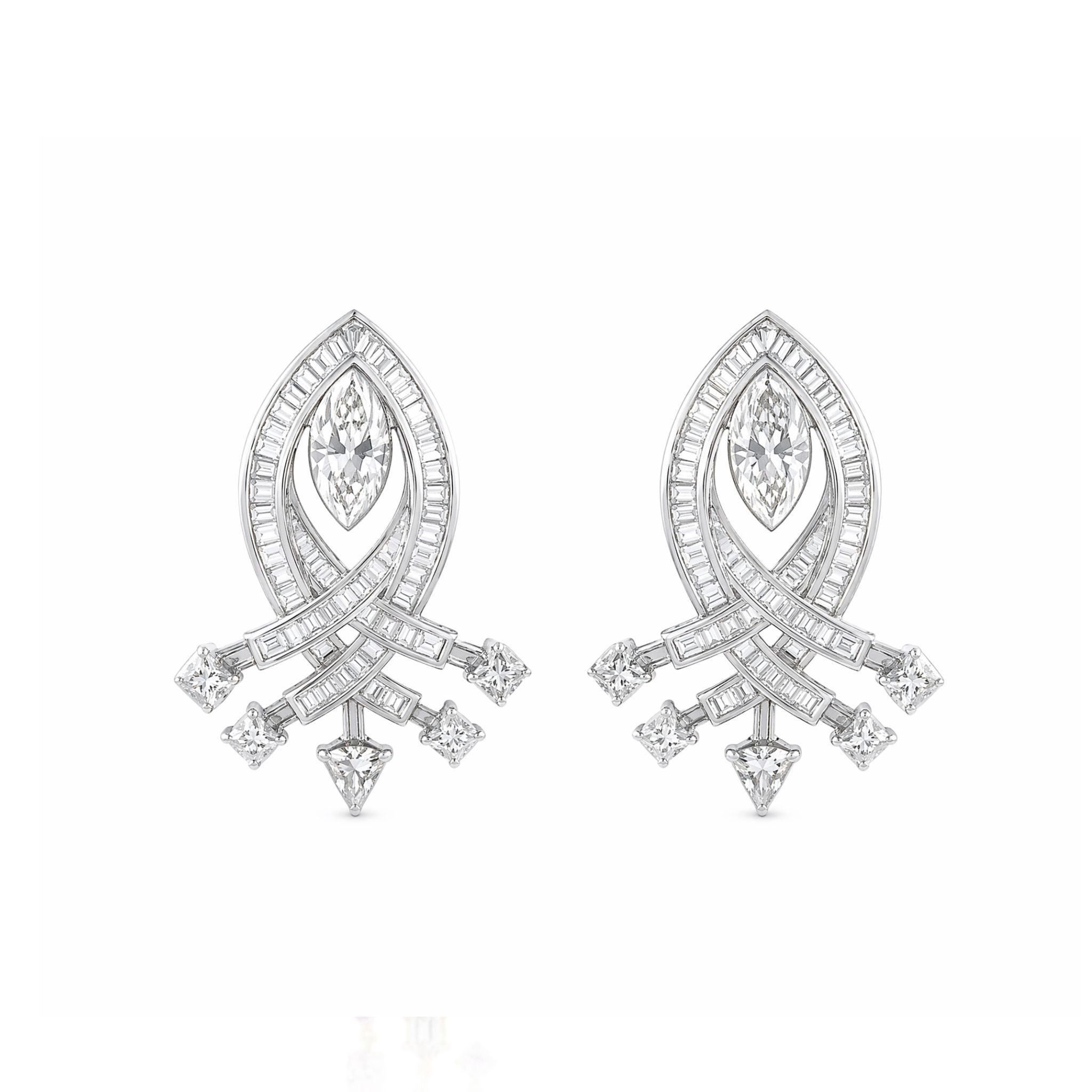 The Pair of Diamond Earrings features a marquise-shaped central gem surrounded by curved rows of baguette and round diamonds, inspired by elegant 1930s jewelry in an intricate, symmetrical silver design.