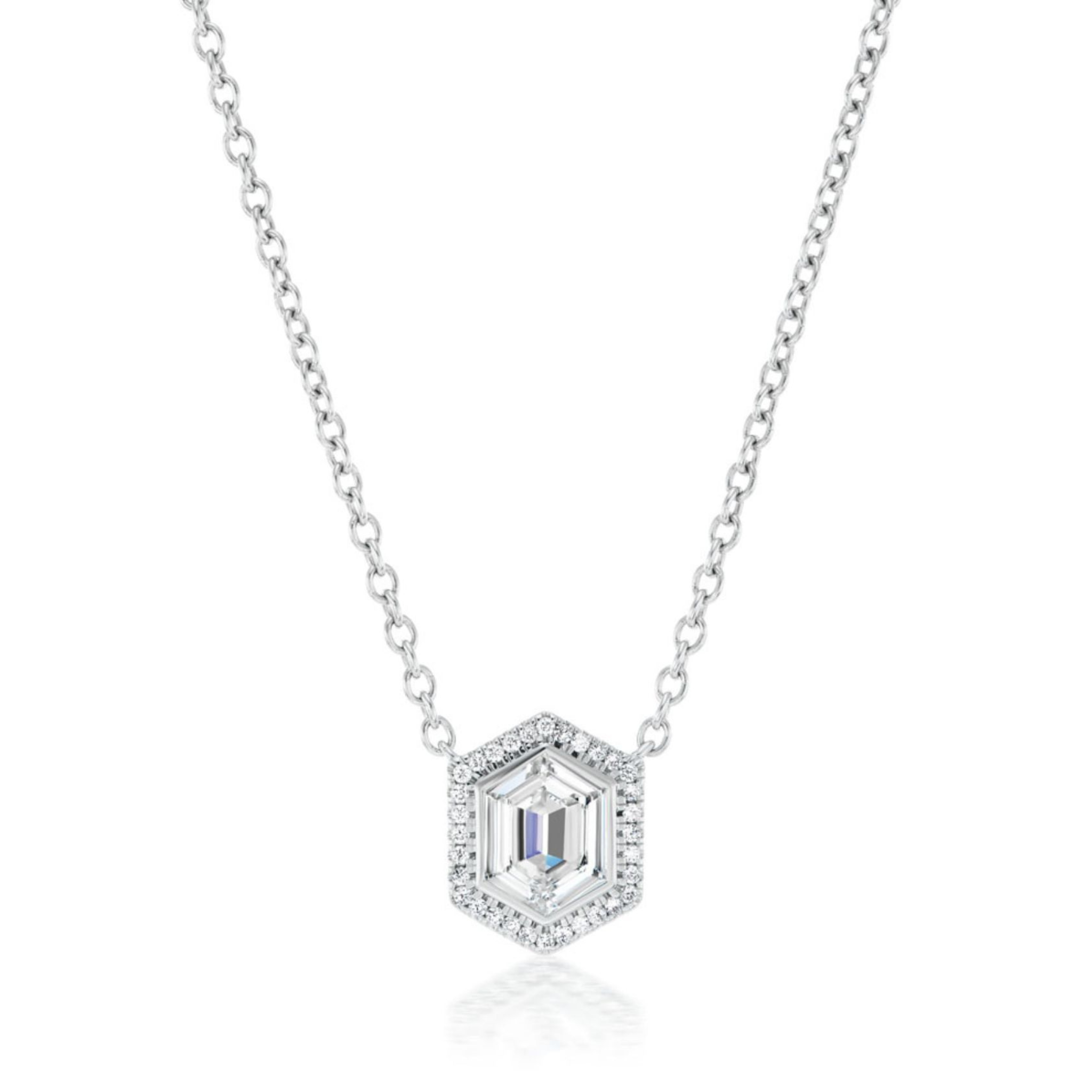 The Pavé Hexagonal Diamond Solitaire Pendant in White Gold features a hexagonal design with shimmering stones encircling the center, showcased on a white background.