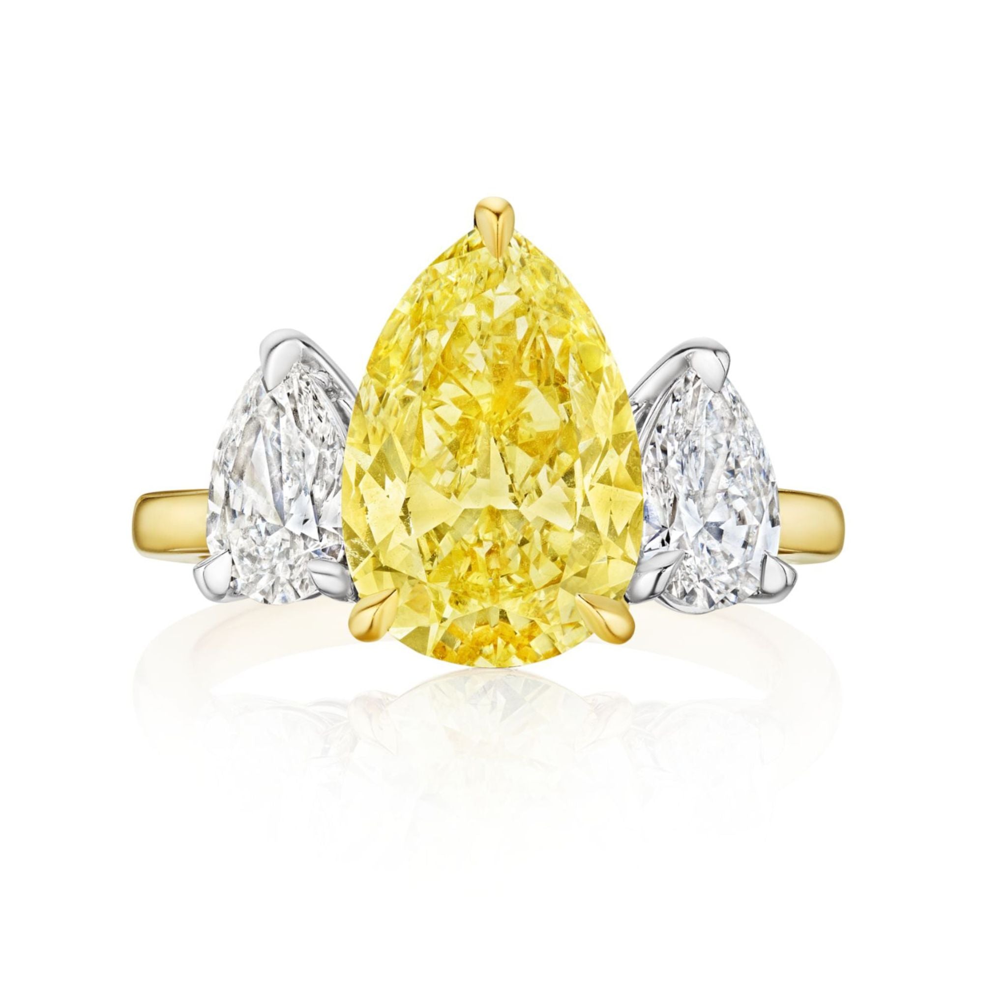 The Pear Shape Yellow Diamond Ring with White Diamond Side Stones showcases a striking yellow diamond center and two pear-shaped white diamond accents in an elegant three-stone design.