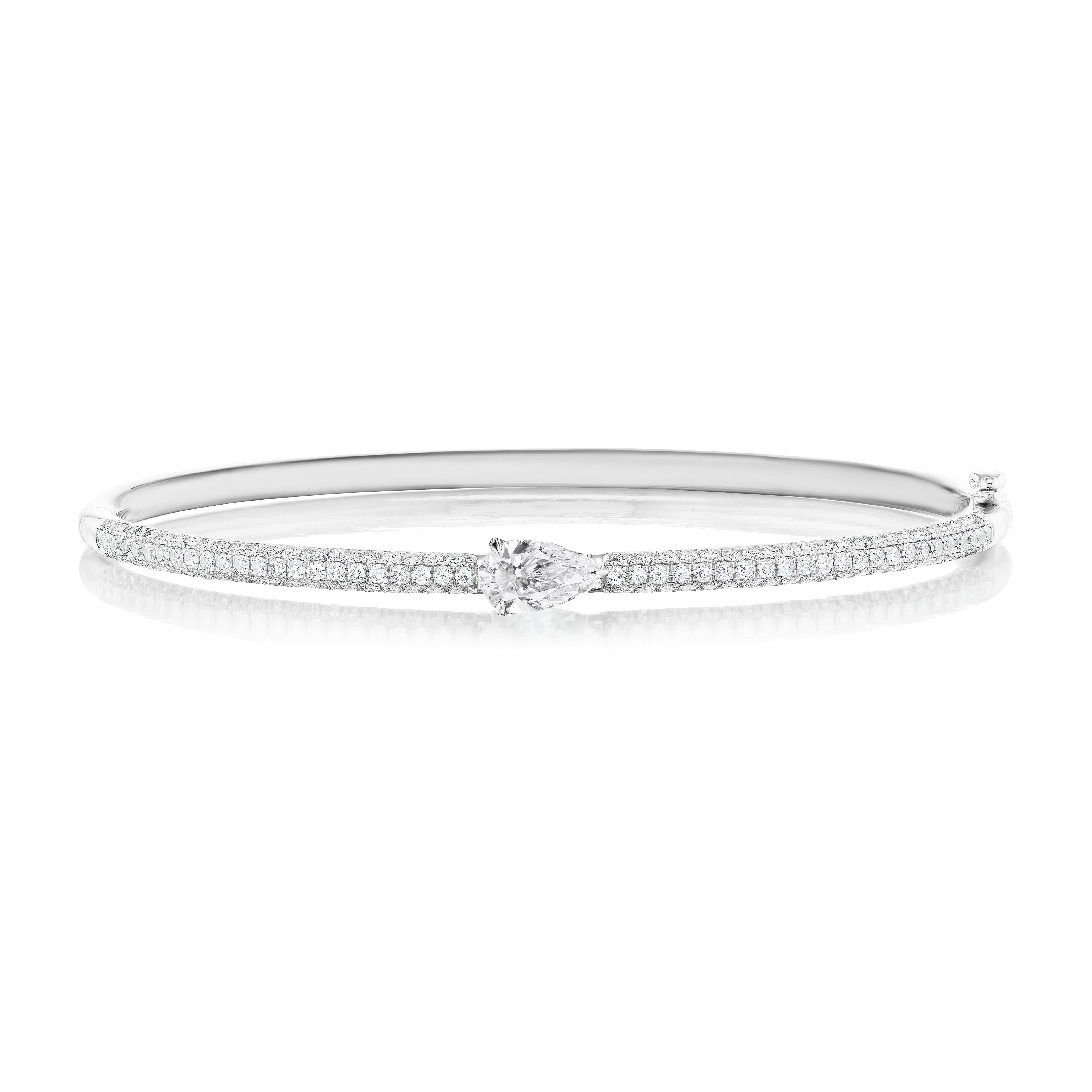 The East-West Set Pear Shape Diamond Pavé Bangle in silver displays a central pear-shaped diamond and two rows of sparkling pavé stones along the band, shown against a white background.