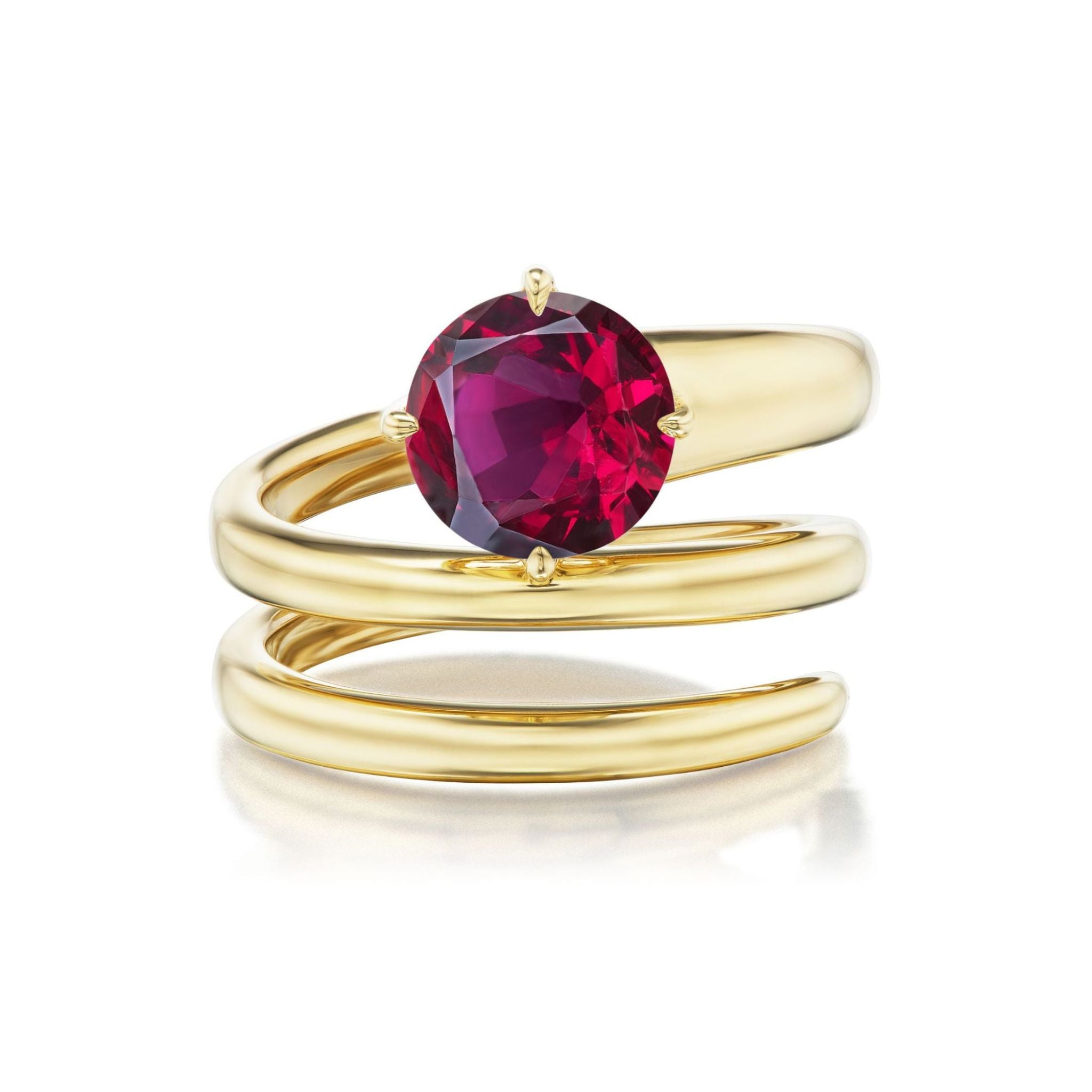 The Pinky Wraparound Ring with Round Ruby showcases three elegant 18k yellow gold bands, beautifully wrapped around the finger and adorned with a striking round ruby gemstone in a centerpiece prong setting.