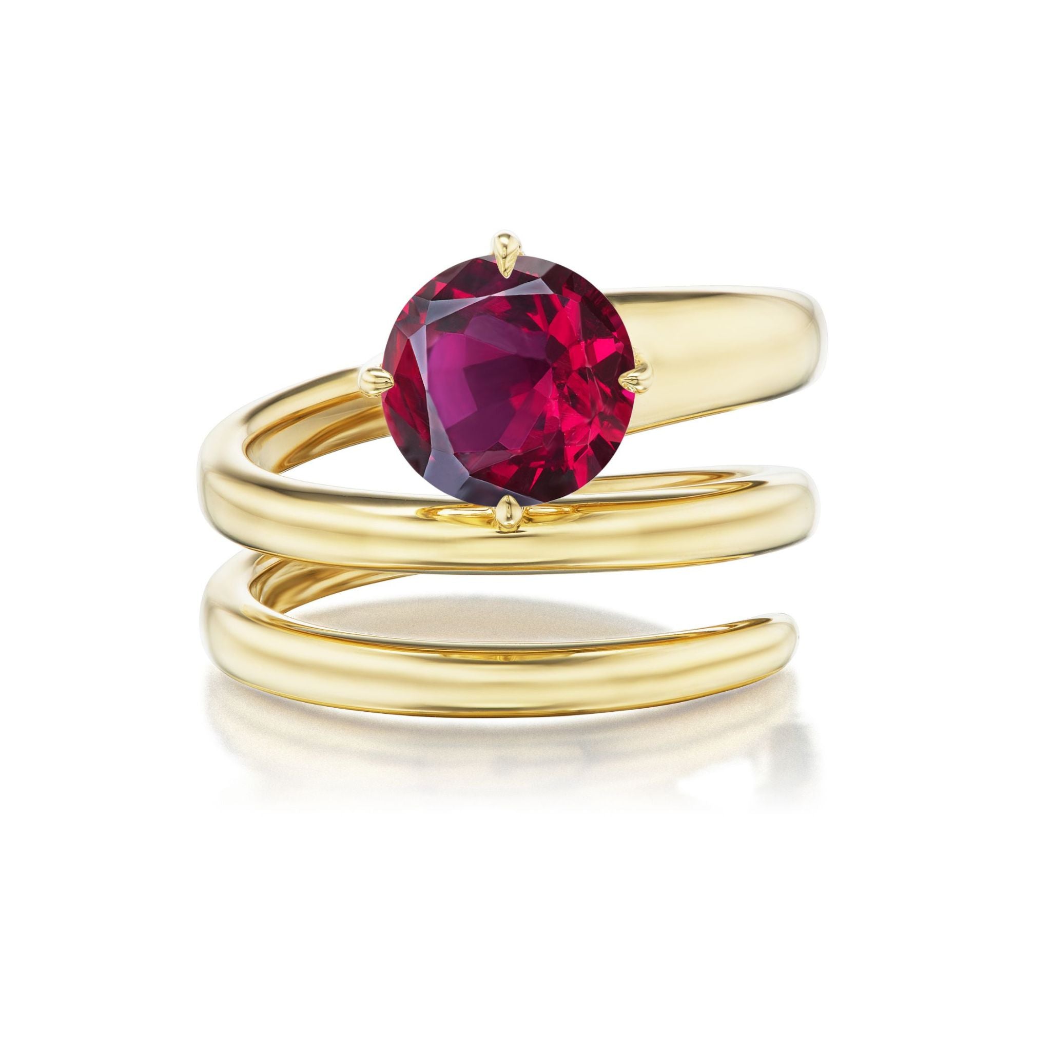 The Pinky Wraparound Ring with Round Ruby features a large, round ruby gemstone set in 18K yellow gold and is displayed on a white surface.