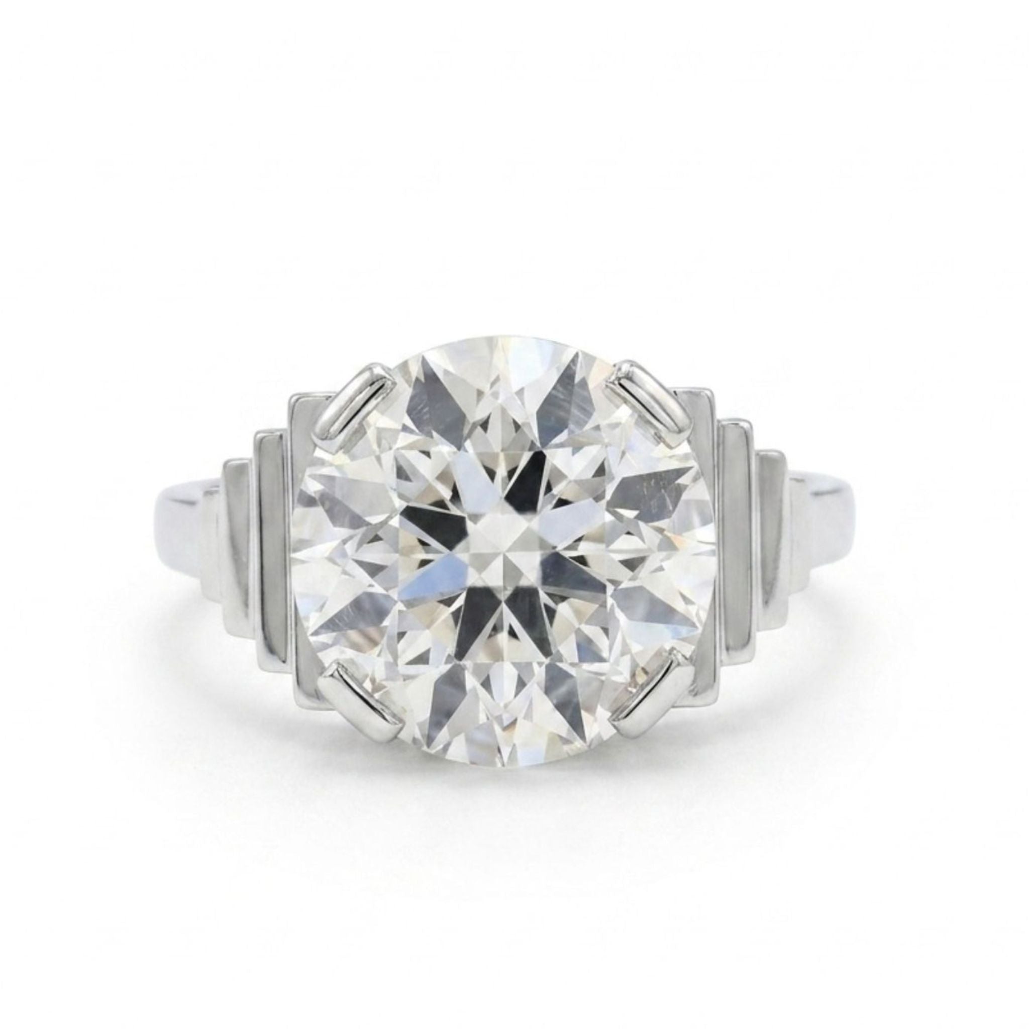 The Platinum and Diamond Ring features a large, round old European-cut diamond centerpiece with stepped geometric accents on each side of the setting.