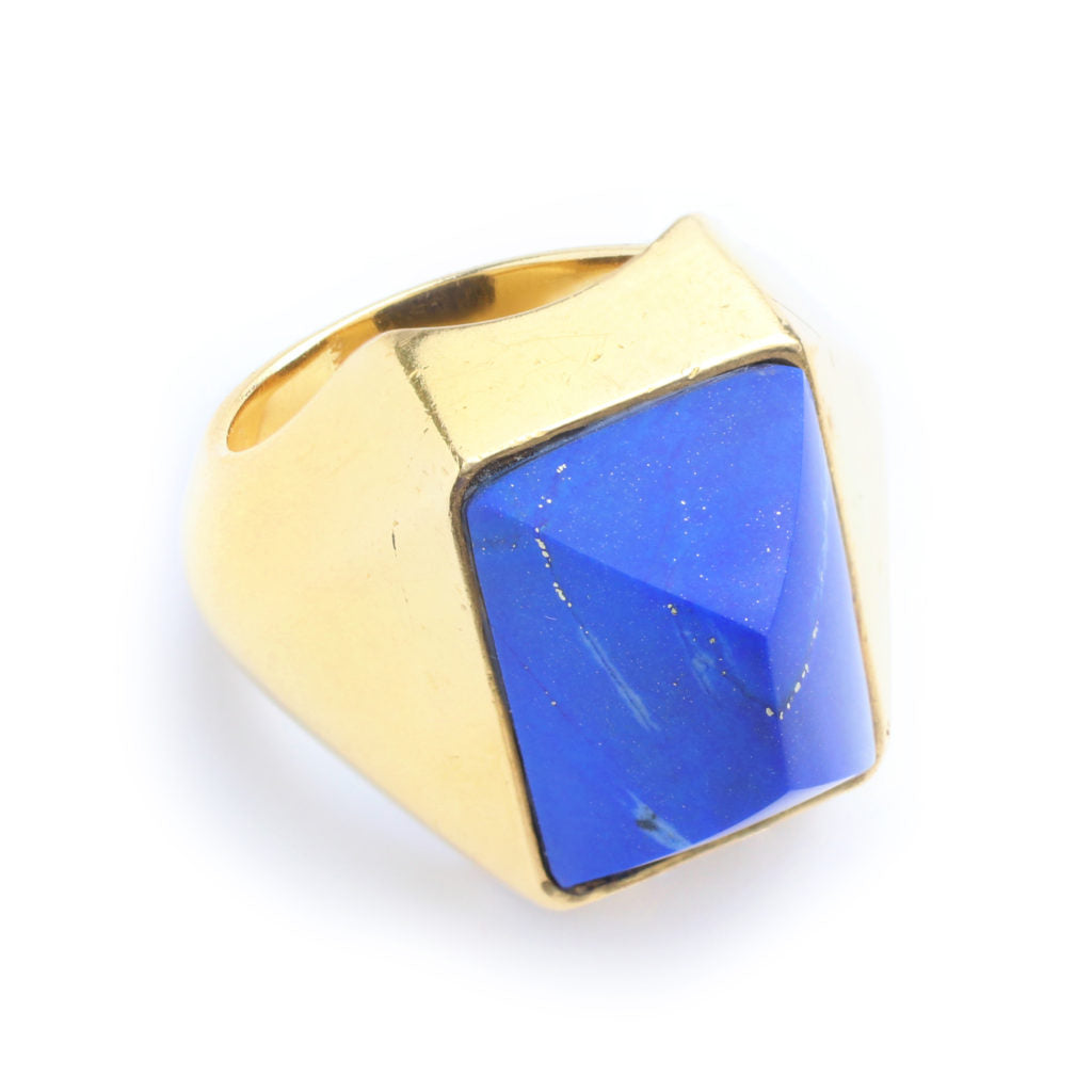 The Boucheron Lapis Lazuli and Gold Ring features a large faceted rectangular lapis lazuli set in a thick 18 karat gold band.