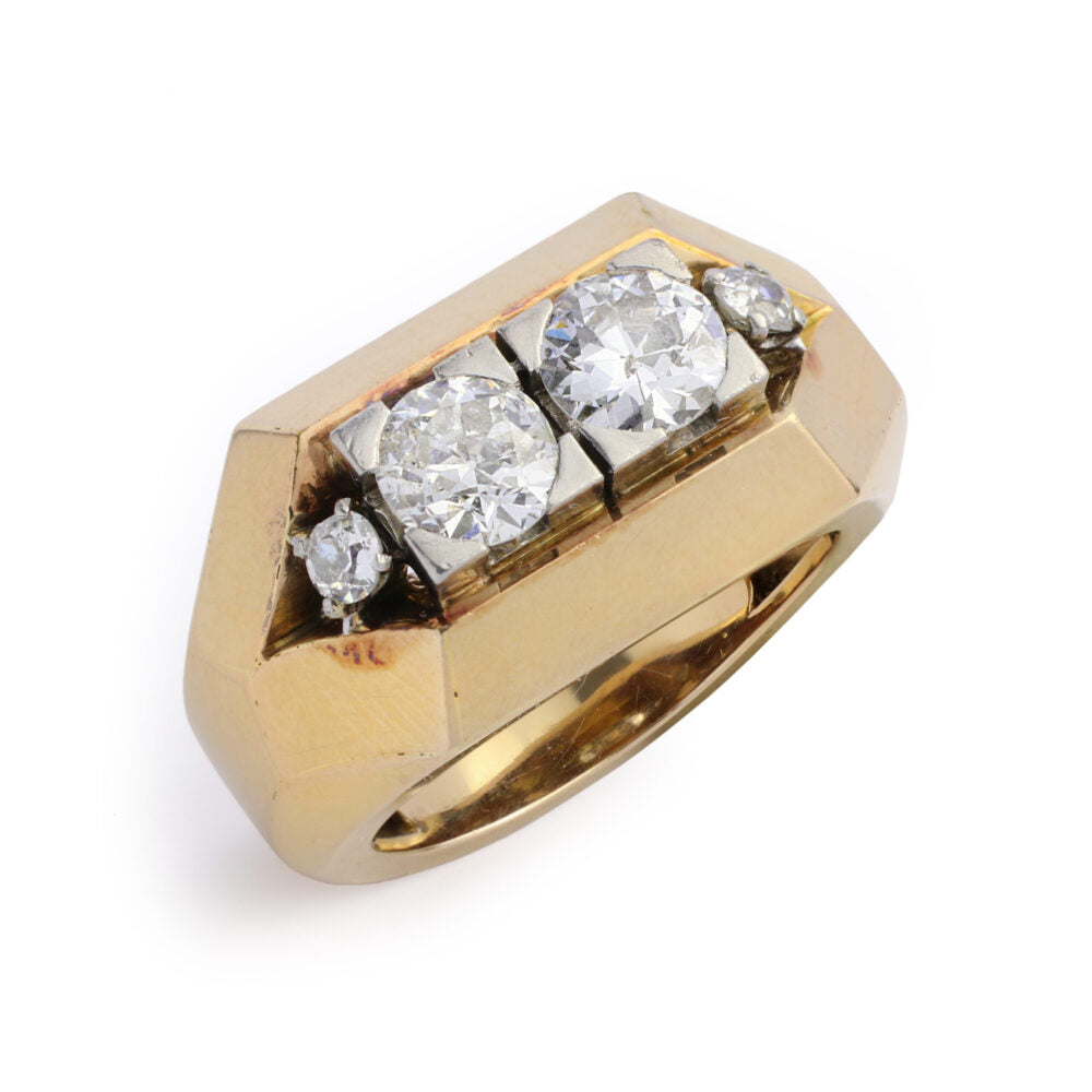 The Mauboussin Gold and Diamond Ring features two large round center diamonds, flanked by two smaller diamonds on each side, all set in a bold geometric chunky gold band.