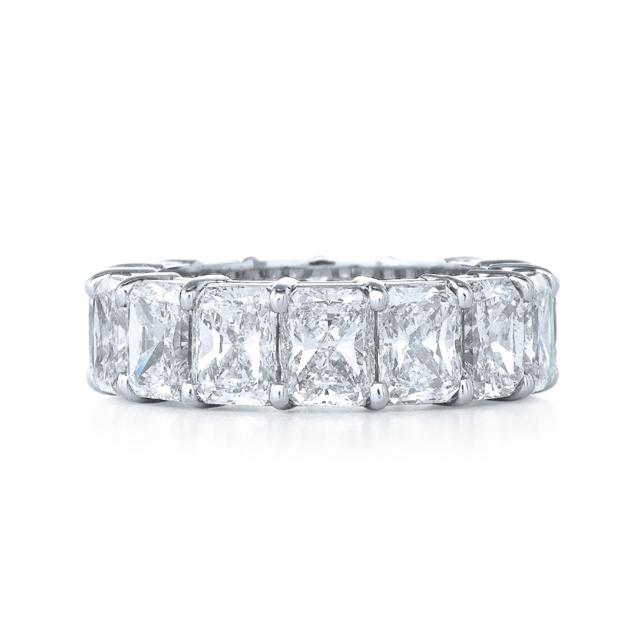 The Radiant Cut Diamond Eternity Band features a seamless row of radiant-cut diamonds in platinum, making it a sophisticated and modern celebration ring.