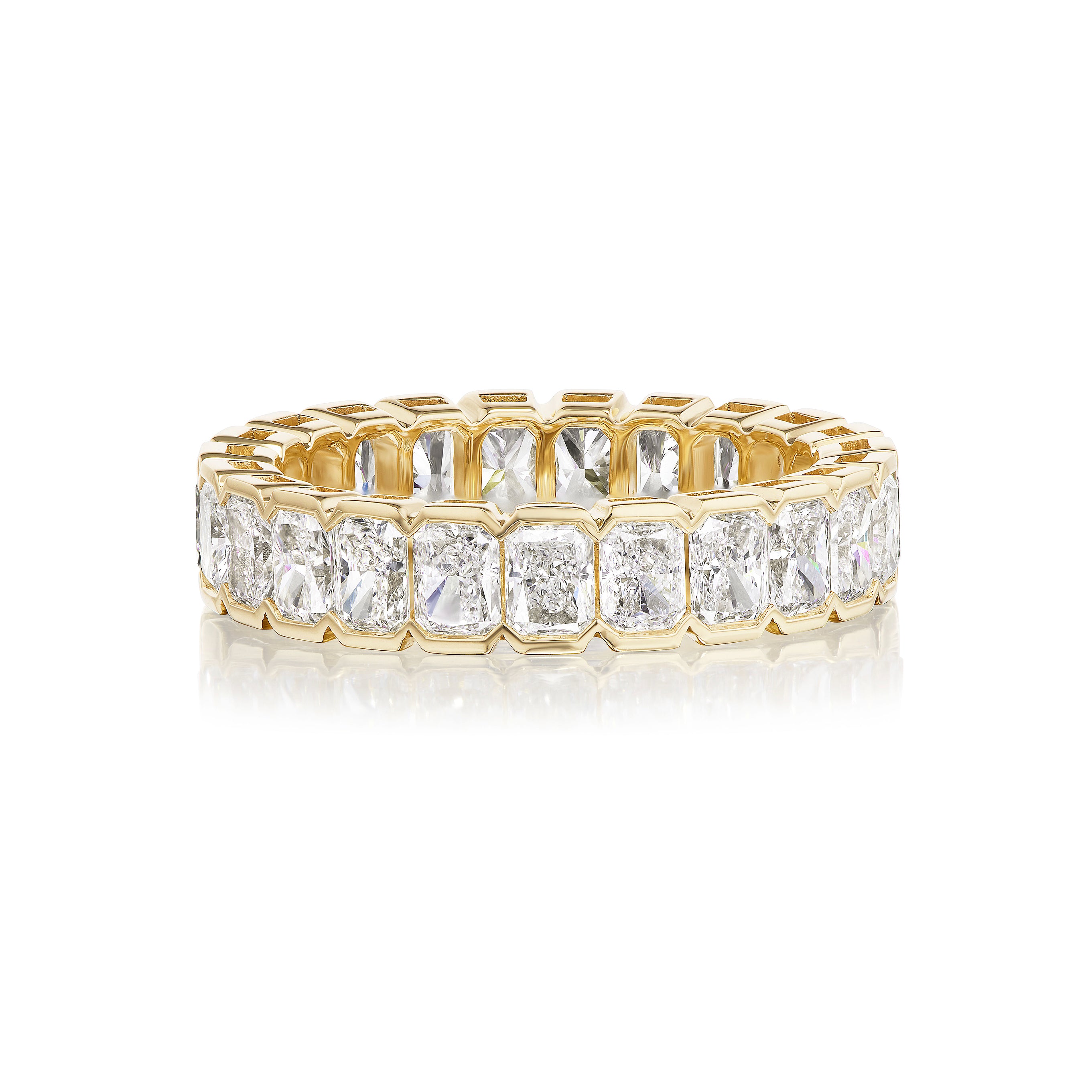 The Radiant Cut Diamond Eternity Band in Yellow Gold is crafted in 18k yellow gold, size 7, and showcases cushion-cut diamonds set in a sleek channel setting.