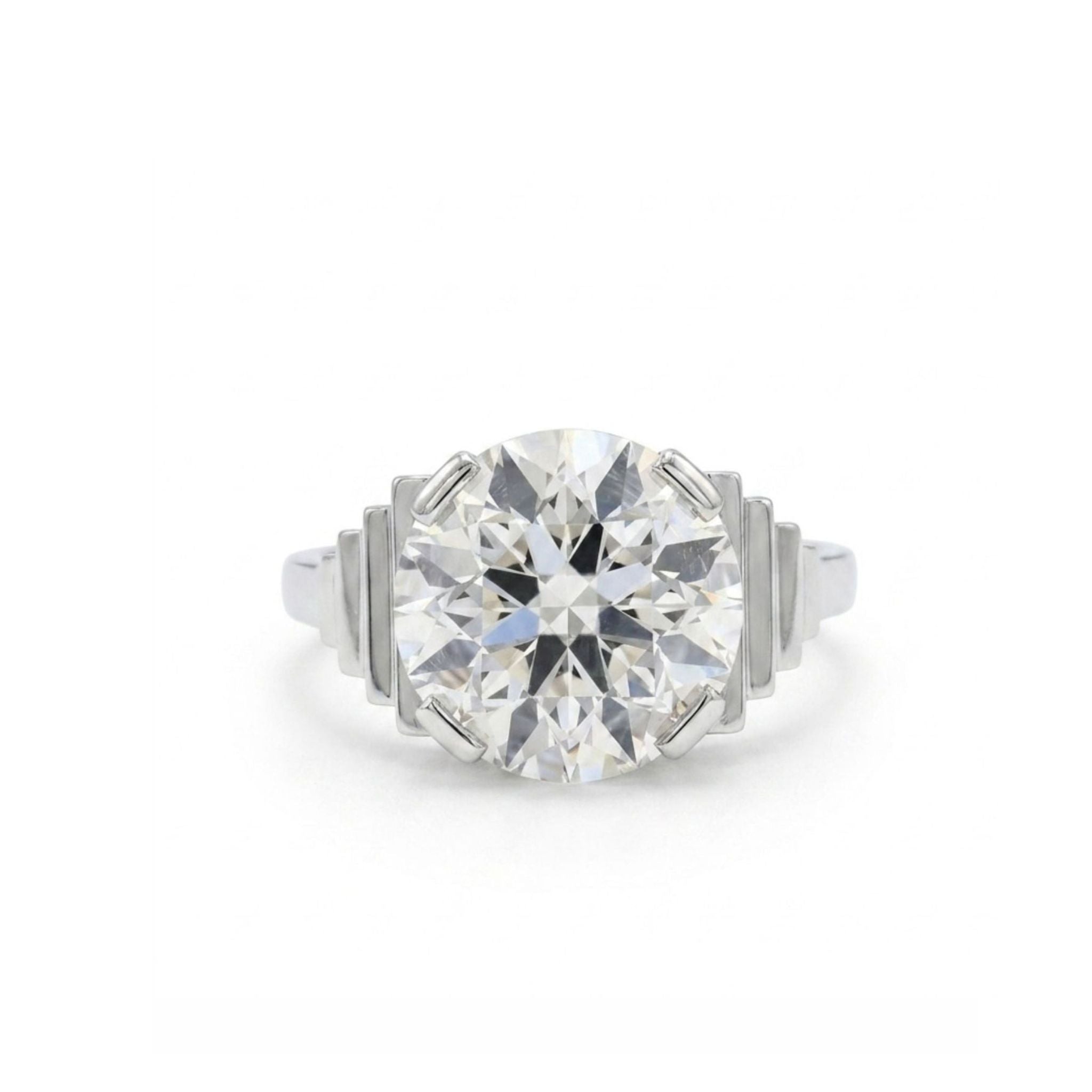 The Platinum and Diamond Ring showcases a striking 4.17 carat old European-cut diamond at its center, accented by geometric, stepped motifs on either side, and is presented against a white background.