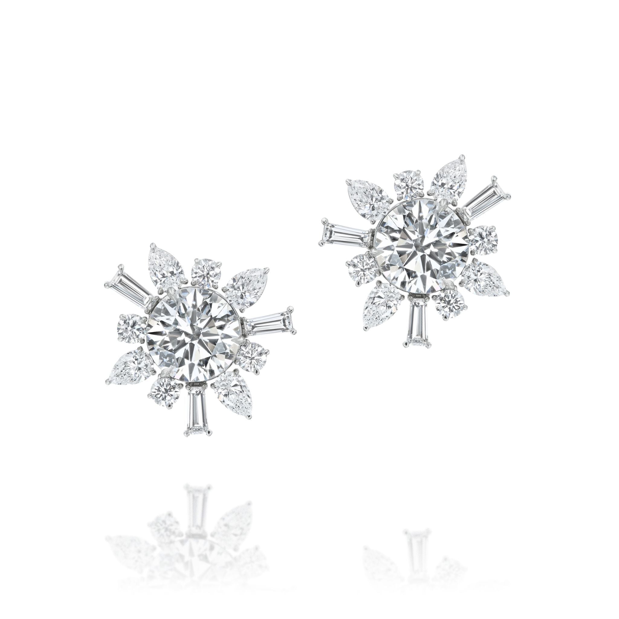 Introducing the Mixed Shape Diamond Ear Jacket in White Gold by Serpentine Jewels—a dazzling design featuring a large round center stone adorned with an array of marquise, baguette, and round-cut diamonds in a striking starburst pattern. This versatile piece is set in radiant white gold and can be paired with its chic ear jacket for added elegance and styling options.