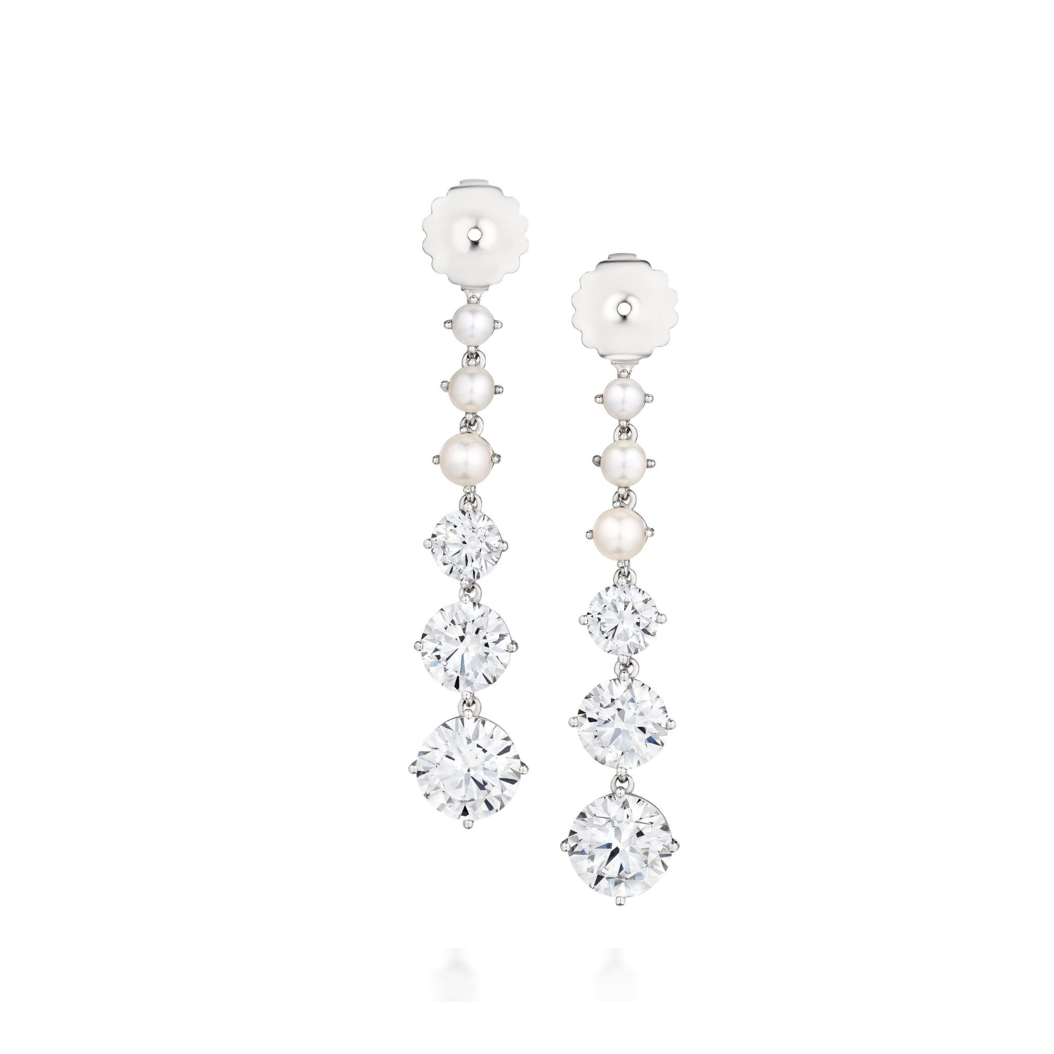 Introducing the Graduated Drop Ear Jackets in White Gold with Pearls and Round Brilliant Diamonds—an elegant pair of earrings featuring a vertical row of lustrous pearls above three sparkling round brilliant diamonds, expertly set in white gold. Perfect for those who appreciate sophisticated and customizable jewelry.