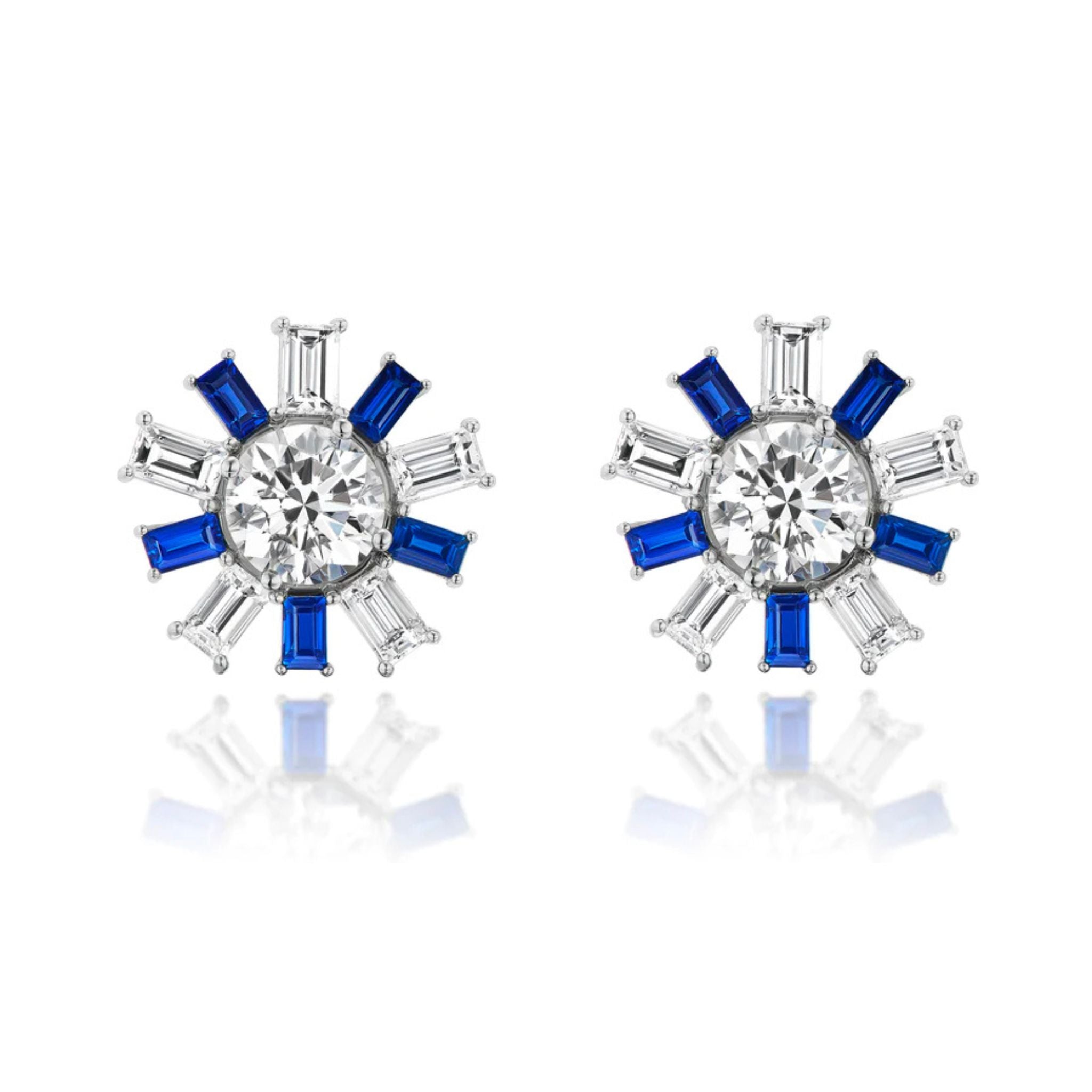 Confetti Ear Jackets in White Gold featuring central emerald cut diamonds, surrounded by alternating blue sapphires and clear emerald cut diamonds in a striking starburst pattern, set in gleaming 18k white gold.