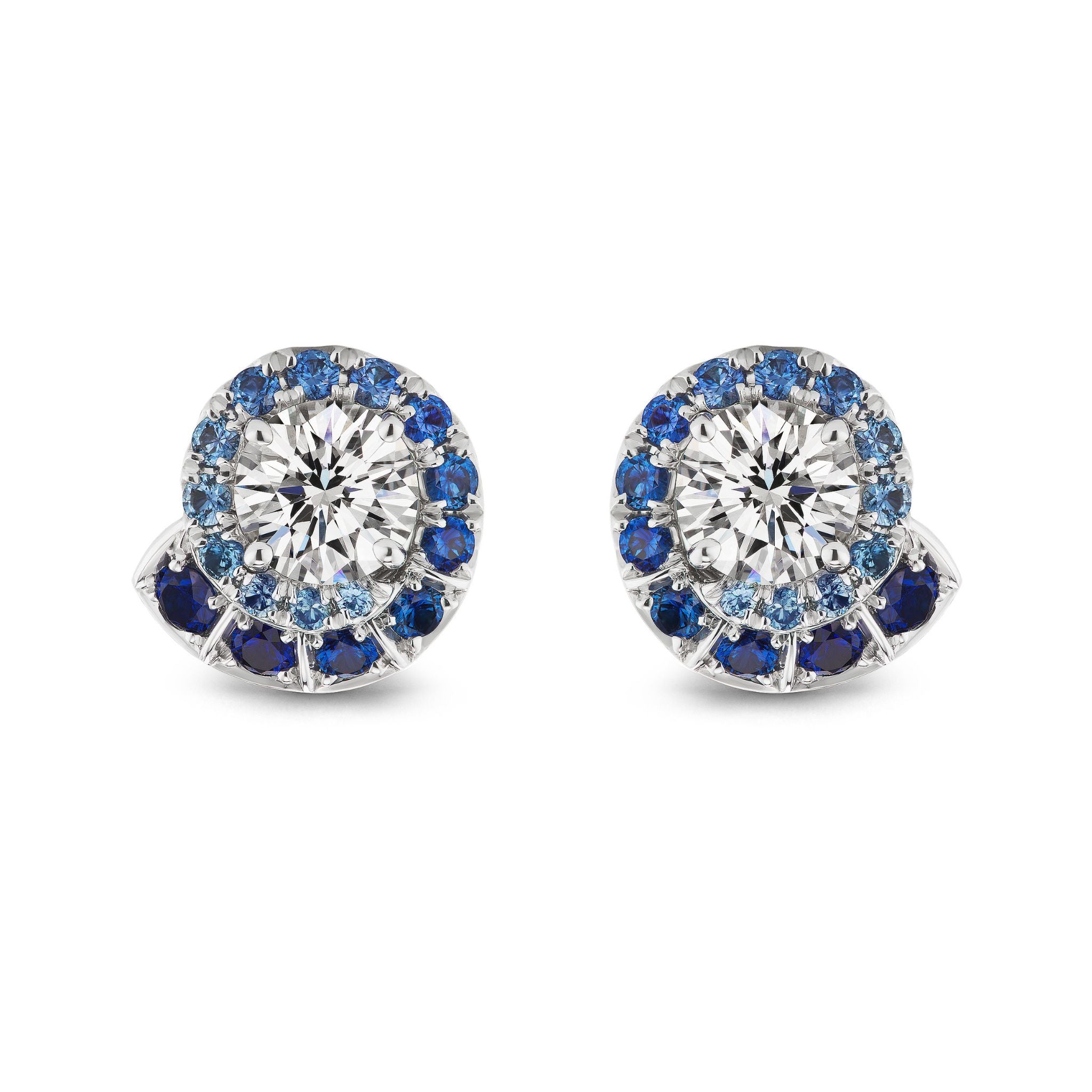 Ombré Swirl Ear Jackets in White Gold feature large central clear stones encircled by a spiral of multicolor sapphires in various sizes. Custom order options are available.