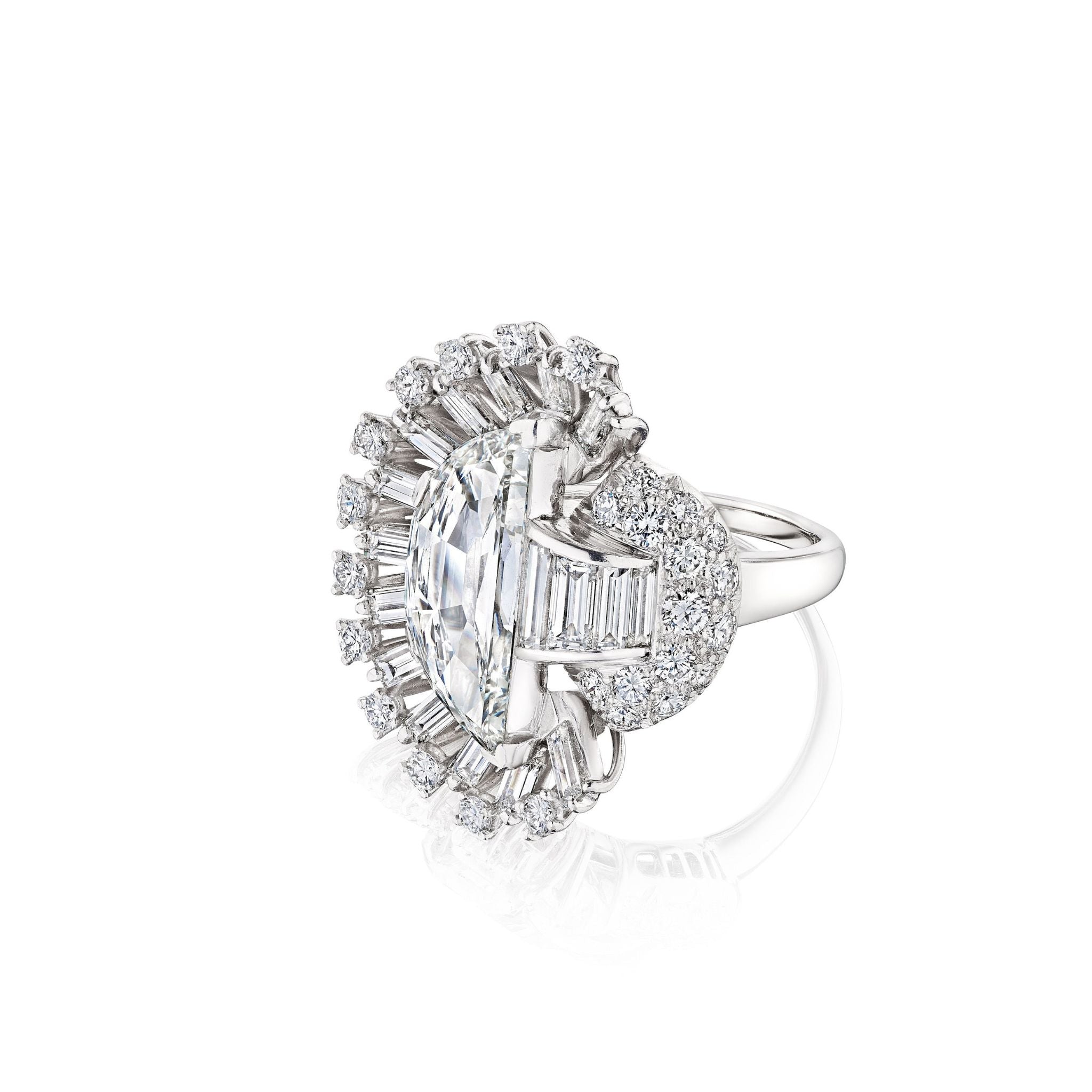 Introducing the Vintage Oscar Heyman & Brothers Diamond Ring: a platinum 1946 creation showcasing an oval center diamond, elegantly framed by baguette and round diamonds—including a distinctive half-moon diamond—set in an intricate, asymmetrical halo atop a simple band, embodying the iconic craftsmanship of Oscar Heyman & Brothers.