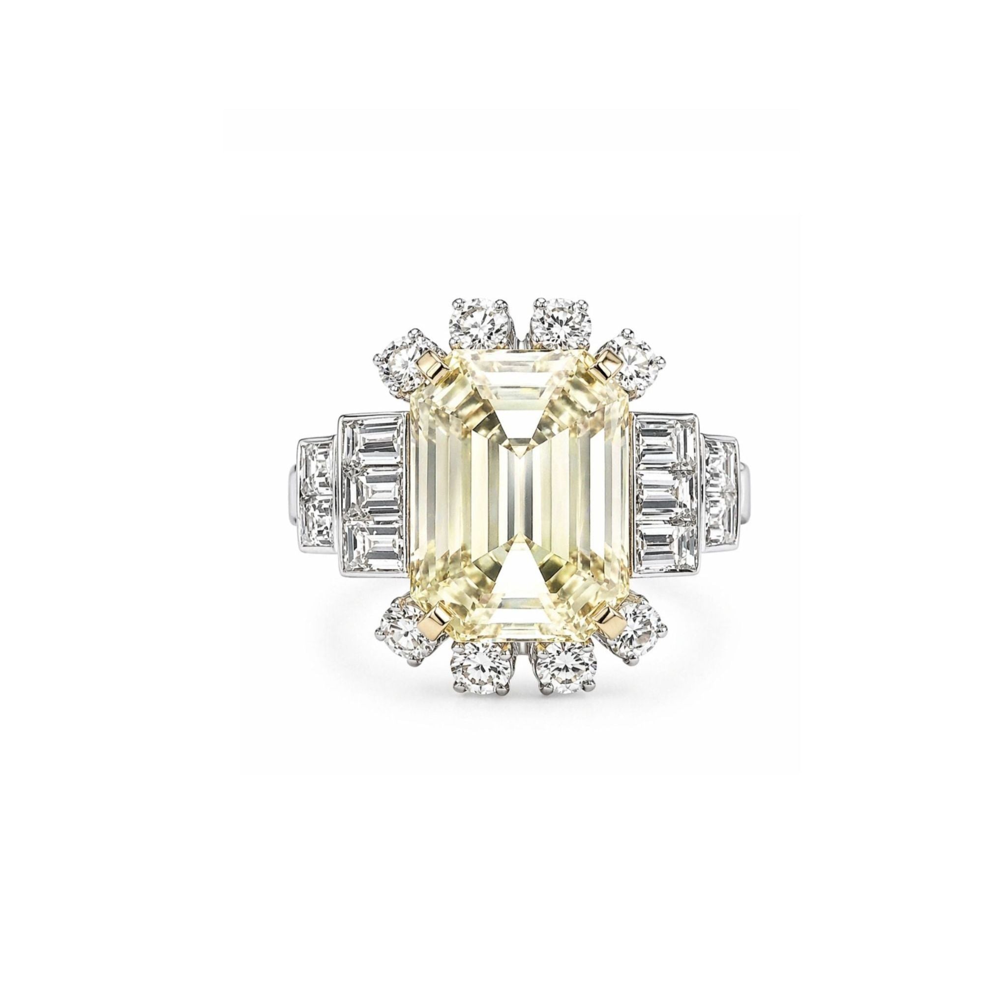 The Yellow Sapphire and Diamond Ring features a large rectangular yellow sapphire surrounded by a sunburst halo of round and baguette diamonds, all set in platinum.