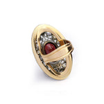 Antique Garnet and Diamond Ring with an oval design, showcasing an intricate lattice pattern and a central garnet gemstone reminiscent of classic antique jewelry, surrounded by fine metal detailing and accent diamonds. The ring is elegantly displayed against a white background.