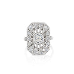 The Art Deco Diamond Ring is an ornate platinum piece with a rectangular sunburst-patterned design, showcasing a central old European-cut diamond surrounded by smaller diamonds—a true reflection of the timeless elegance found in vintage masterpieces from 1925.