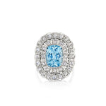 The Aquamarine and Diamond Ring features a stunning oval blue aquamarine set at the center of a gleaming silver band, surrounded by two rows of sparkling round diamonds in an ornate double halo setting—a design that beautifully echoes the elegance of 1910s antique jewelry.