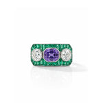 Product Name: Sapphire, Emerald and Diamond Ring A vintage platinum ring featuring a rectangular emerald-cut sapphire as the central purple gemstone, accented by two old European-cut diamonds and bordered by a row of petite emerald gemstones.