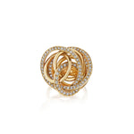 The Gold and Diamond Ring showcases elegant interlocking loops crafted in 18K gold, each embellished with sparkling pavé diamonds, beautifully presented against a white background.