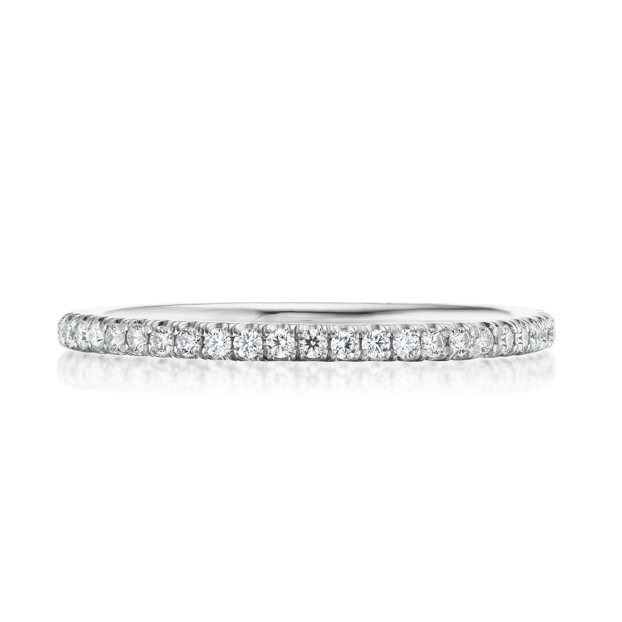The Round Diamond Eternity Band is a thin, elegant 18K white gold ring with a continuous row of small round diamonds set closely together along the band, shown on a white background.